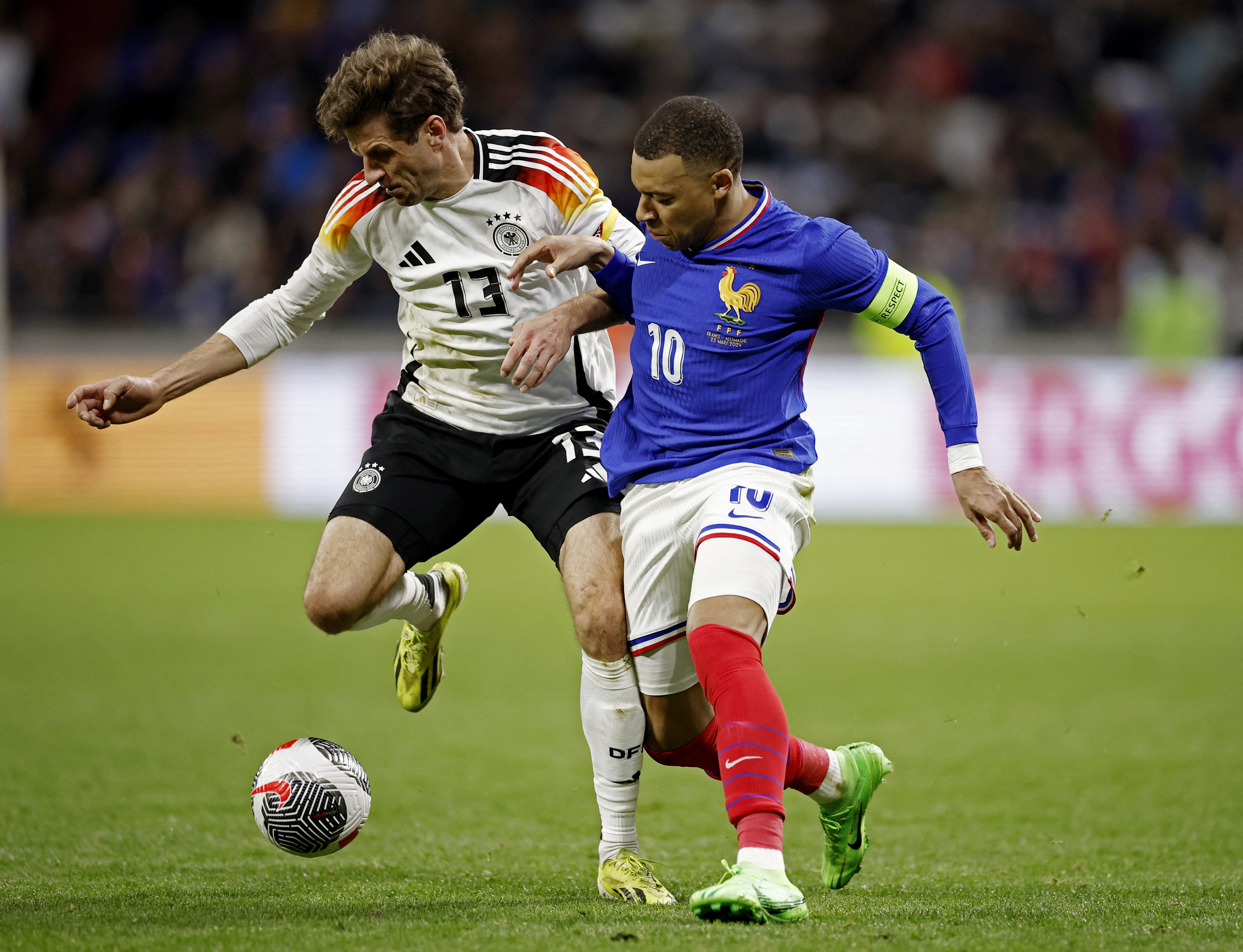 Soccer Football - International Friendly - France v Germany - Groupama Stadium, Lyon, France - March 23, 2024 Germany's Thomas Muller in action with France's Kylian Mbappe REUTERS/Benoit Tessier