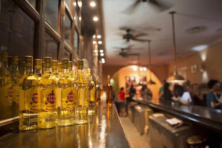 Bottles of Havana Club rum are displayed inside a bar in Havana
