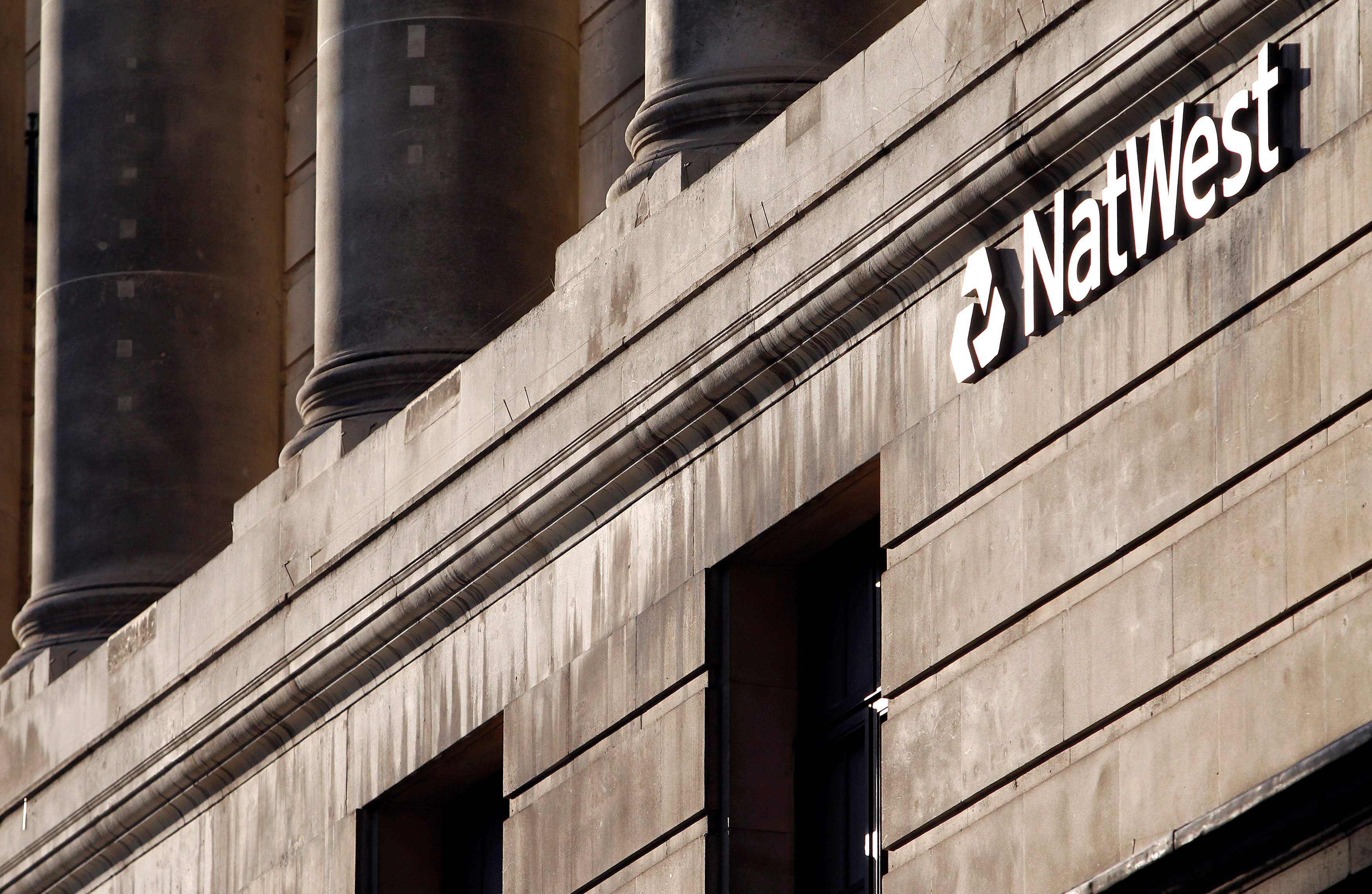 A branch of NatWest Bank is seen in the City of London February 8, 2011. Britain slapped an extra 800 million pound ($1.3 billion) tax on banks this year, taking a harder line on the sector as it negotiates a deal to curb bonuses and free up business lending. REUTERS/Chris Helgren