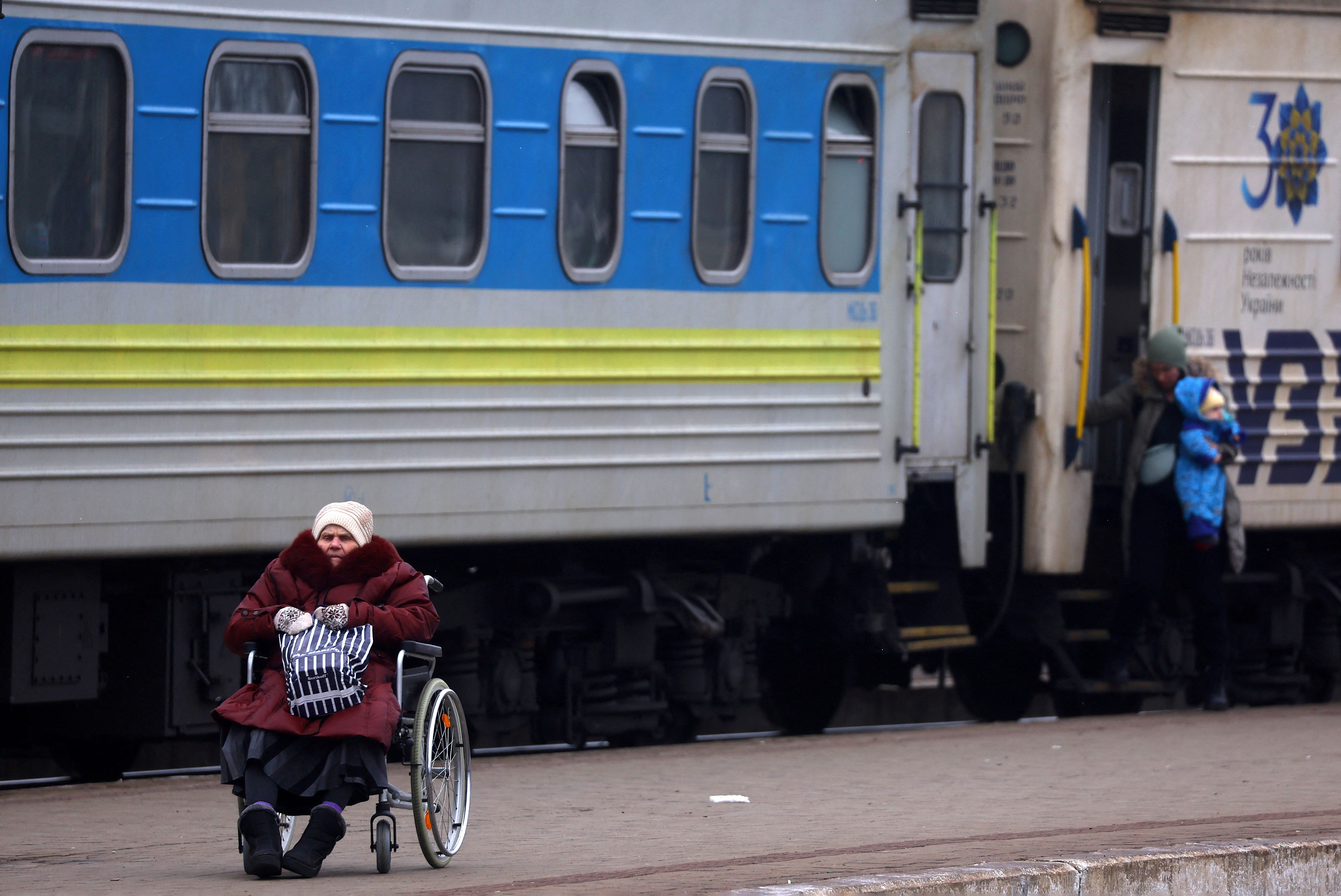 Refugees fleeing the Russian invasion wait for transit in Lviv