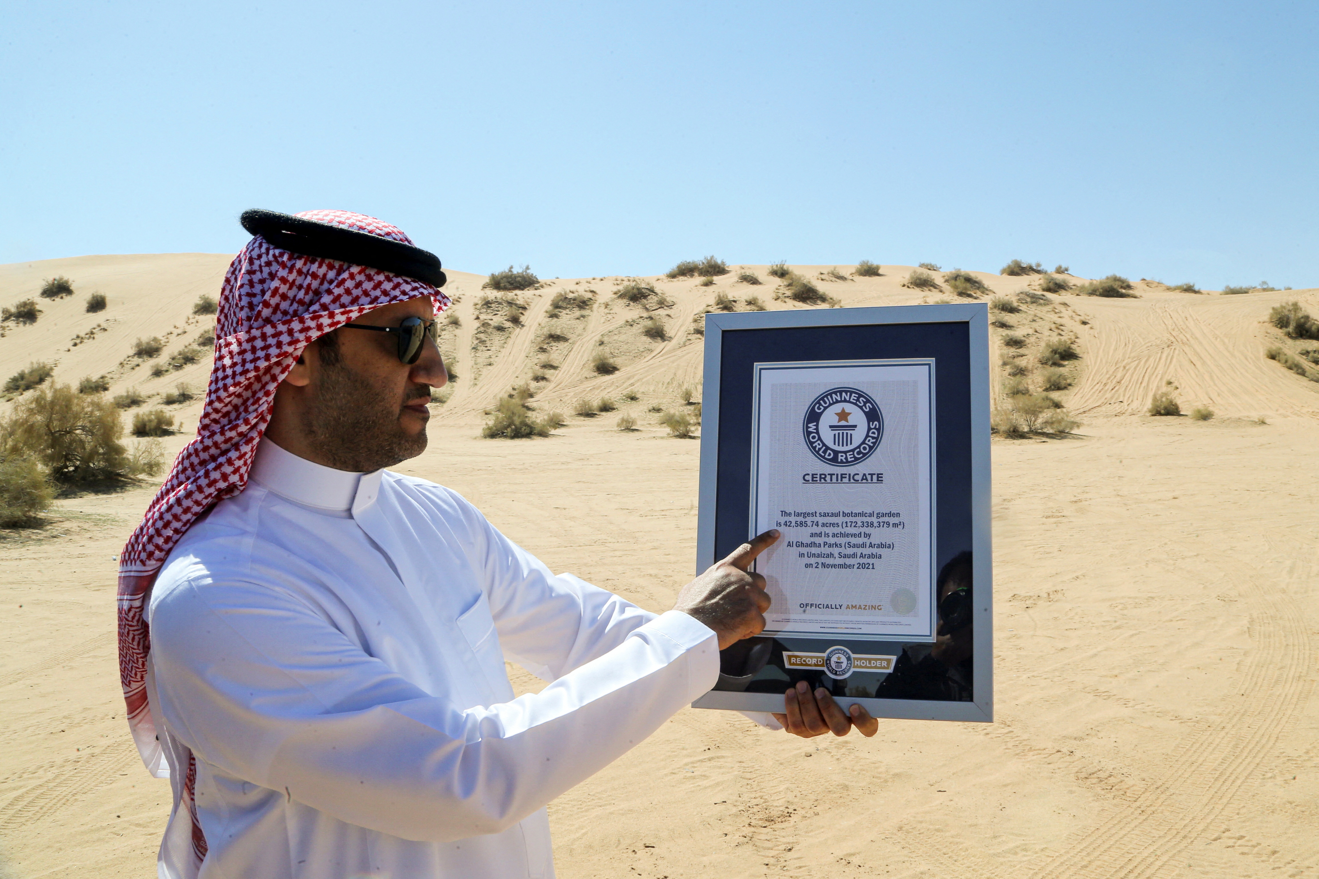 Majed Al-Solaim, CEO of Al-Ghadha Parks shows the Guinness World Record Certificate of the largest saxaul botanical garden, in Unayzah