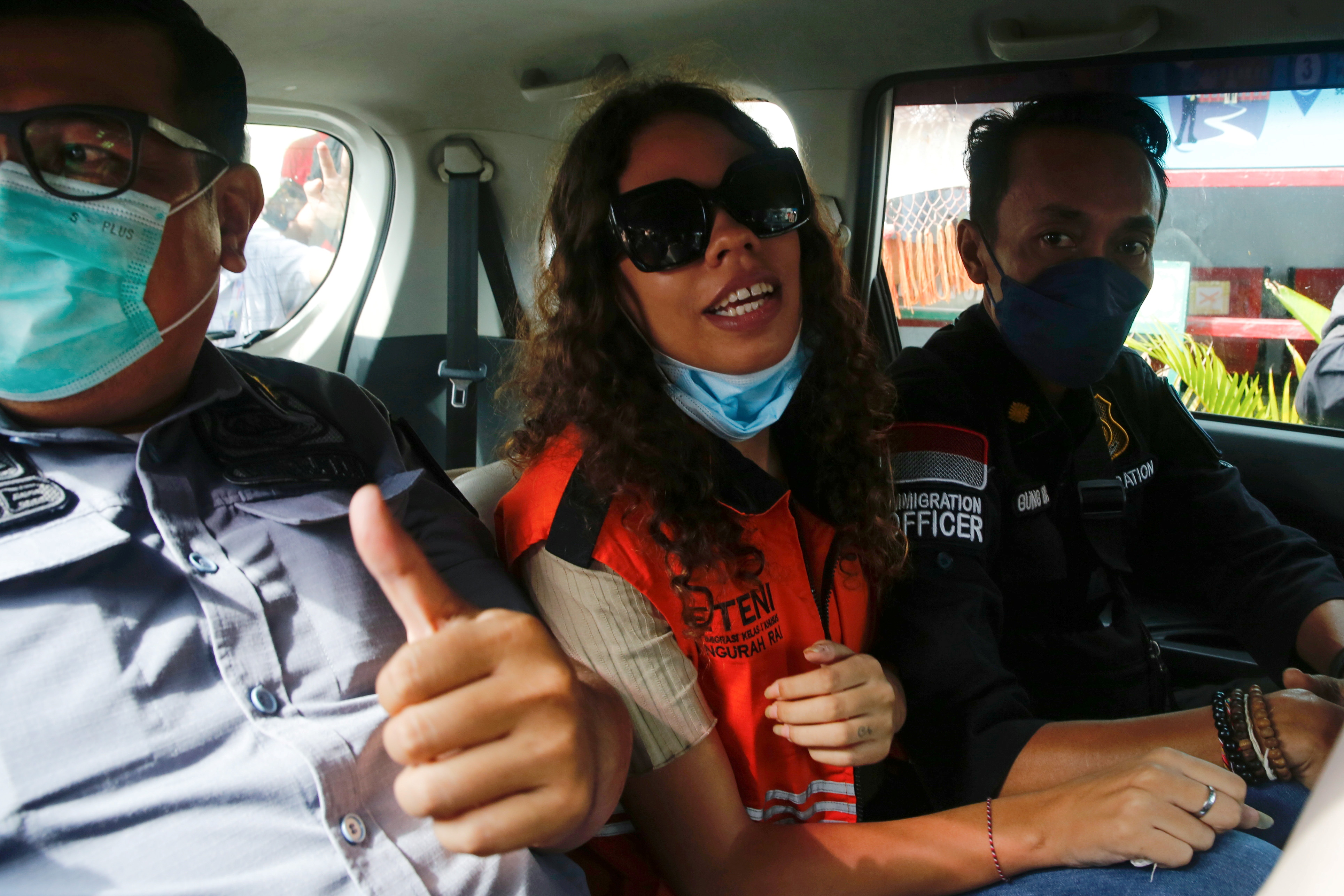 Heather Mack, an American woman jailed in 2015 with her boyfriend after being found guilty for playing a role in murdering her mother and stuffing the remains in a suitcase, is seen inside an immigration car, after being released from Kerobokan Prison in Denpasar, Bali, Indonesia, October 29, 2021. REUTERS/Johannes P. Christo