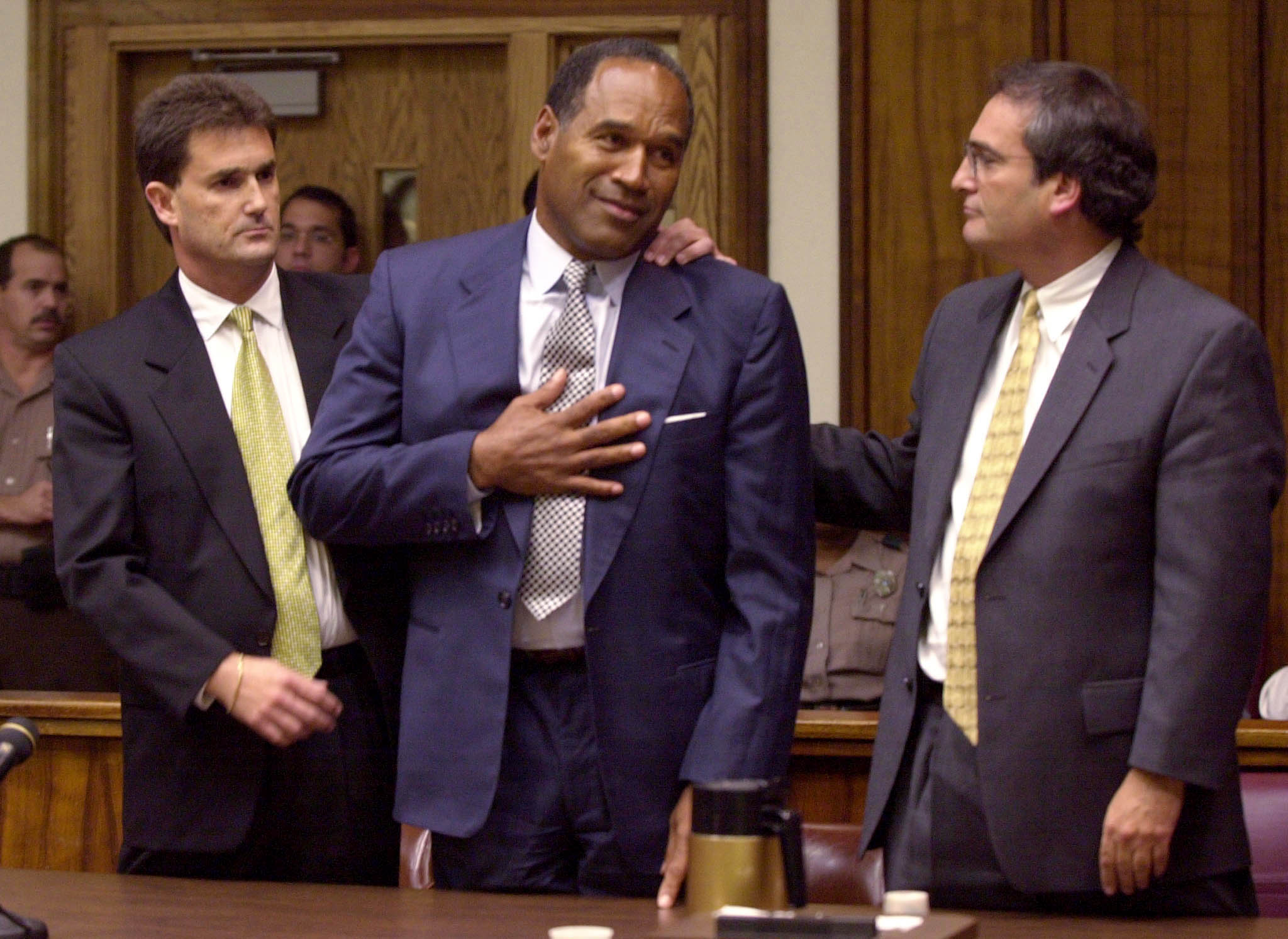 OJ SIMPSON REACTS WITH ATTORNEYS AFTER HEARING NOT GUILTY VERDICT.
