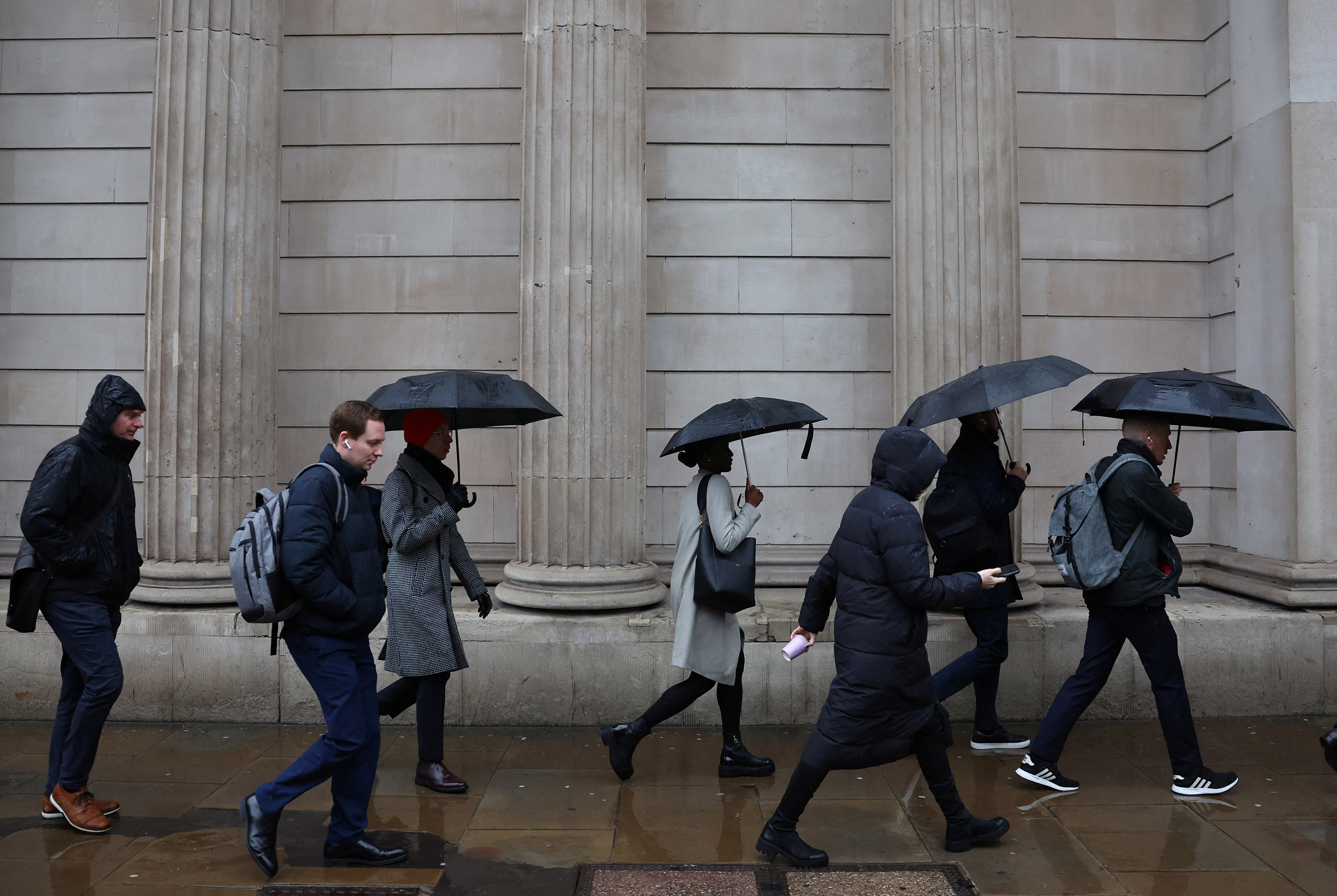 Commuters walk in City of London financial district in London