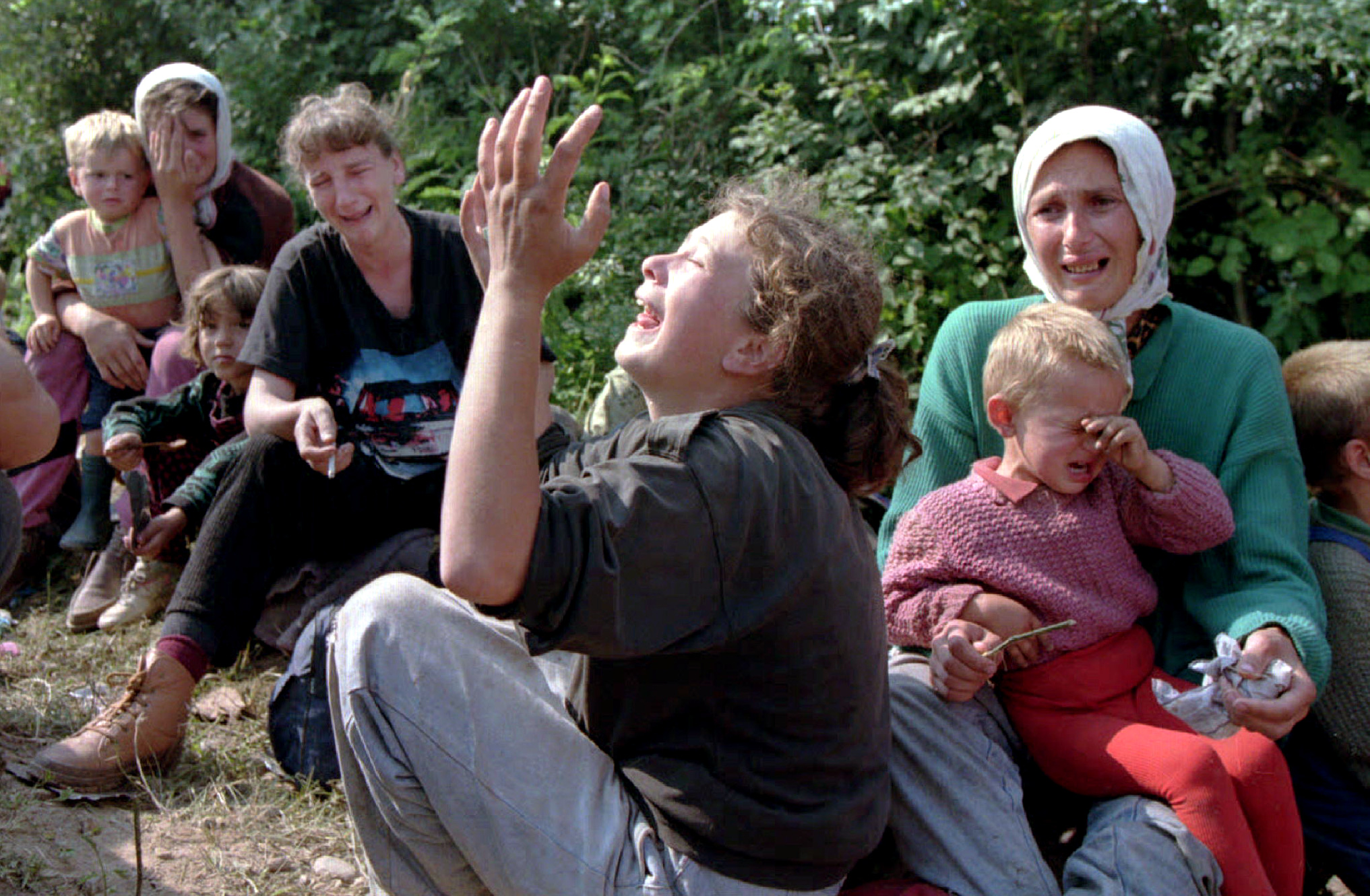 Bosnian refugees from Srebrenica wail over their missing men in the refugee camp at the Tuzla airpor..