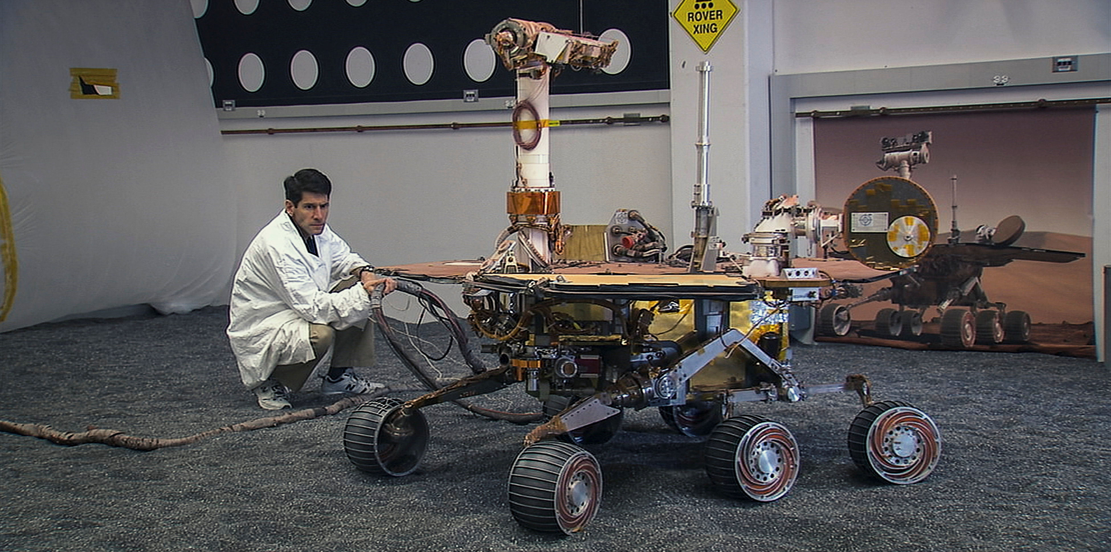 An engineer looks at Mars rover Opportunity at NASA JPL in Pasadena