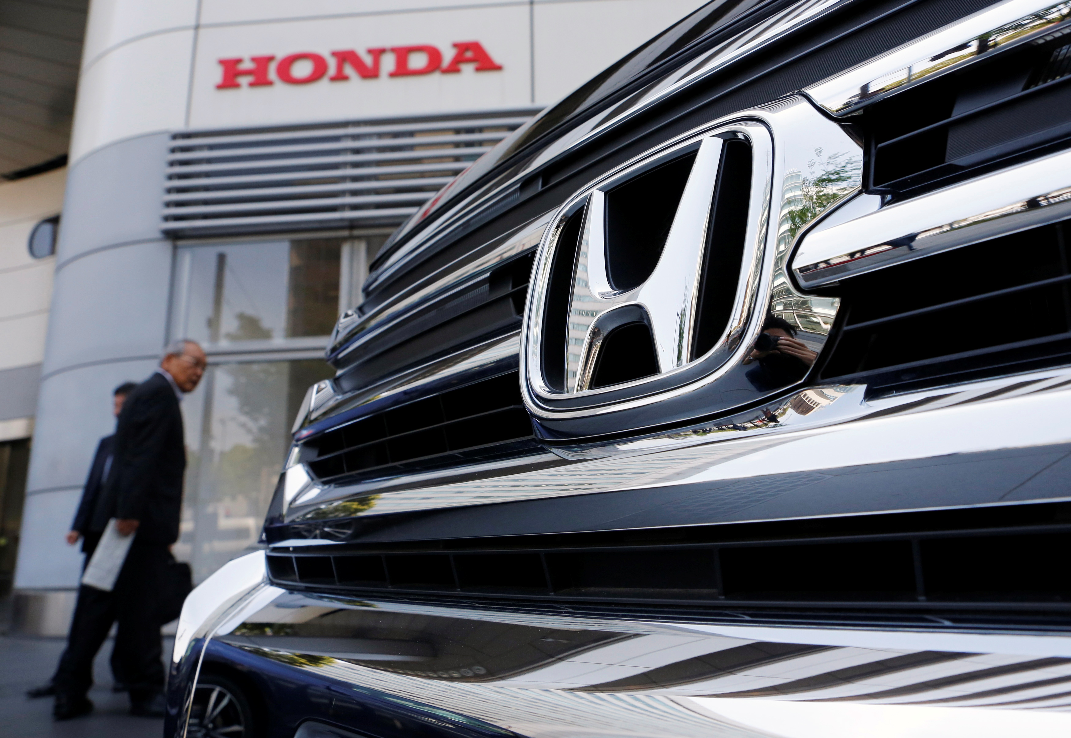 Visitors look at a Honda Motor Co vehicle in Tokyo