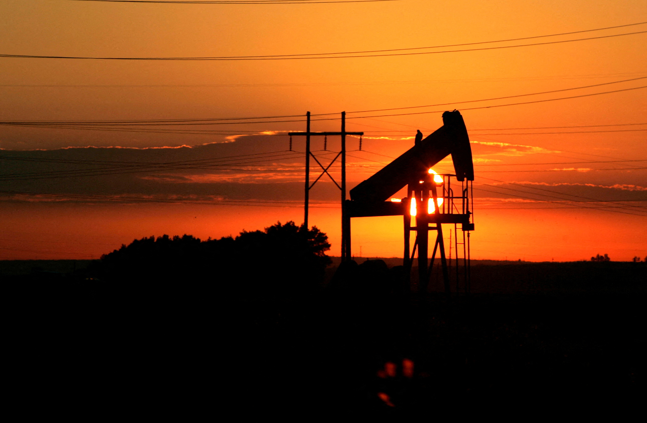 An oil well is seen at dawn near Fort Lupton, Colorado