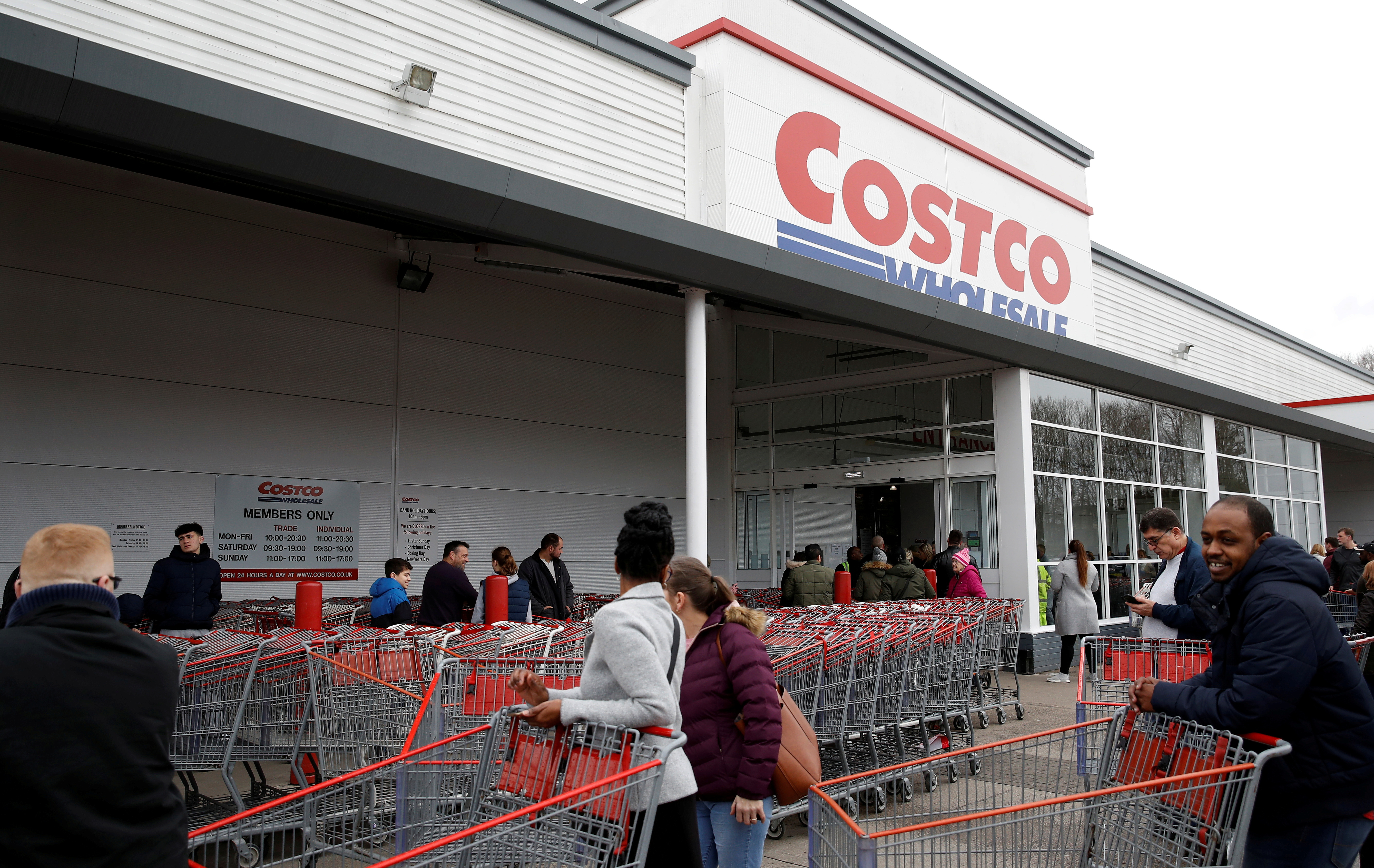 People form a long queue as they wait for the Costco Wholesale store to open in Manchester