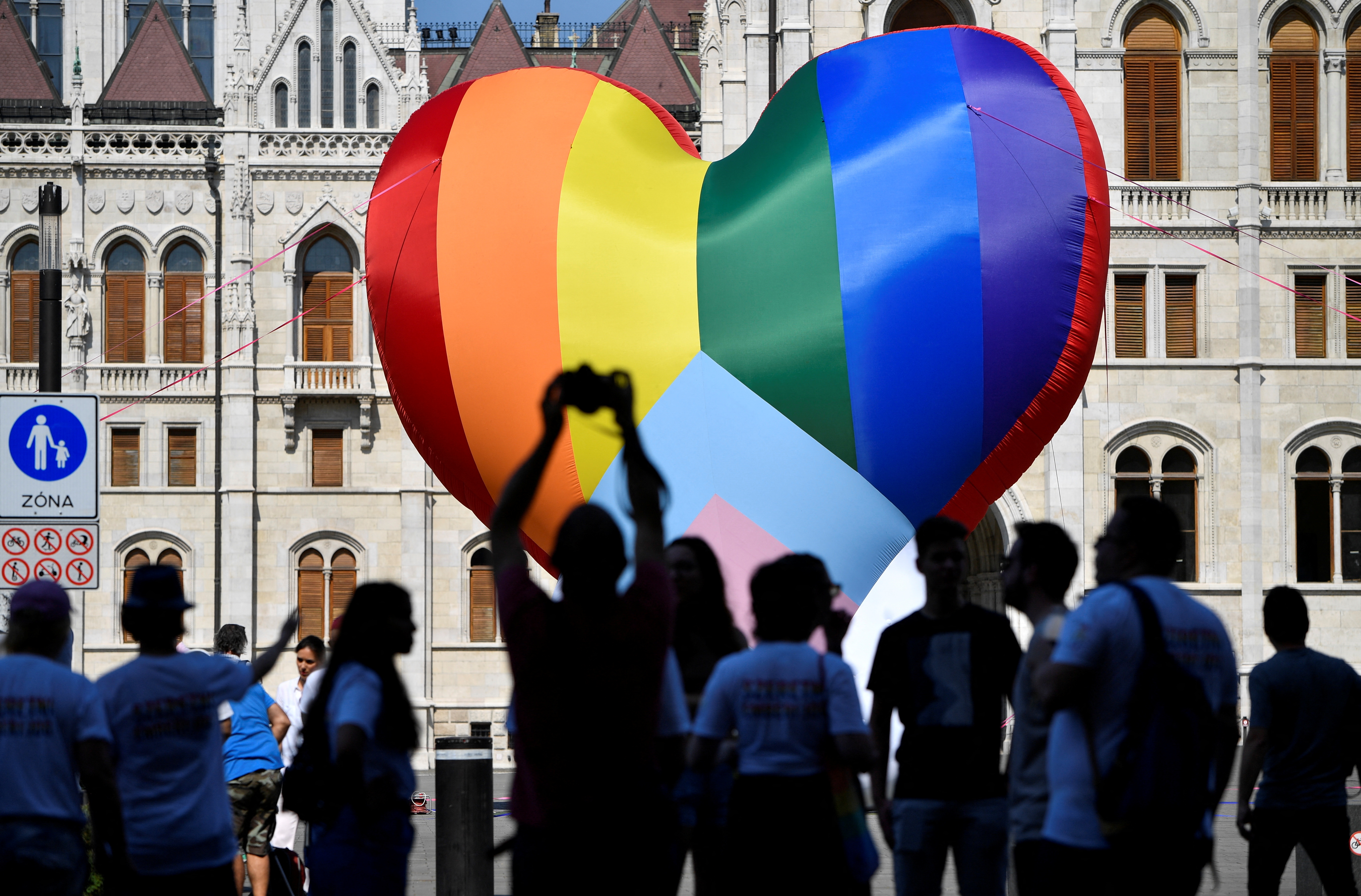 People gather in front of a huge rainbow balloon put up by members of Amnesty International and Hatter, an NGO promoting LGBT rights, at Hungary's parliament in Budapest, Hungary, July 8, 2021. REUTERS/Marton Monus/Files