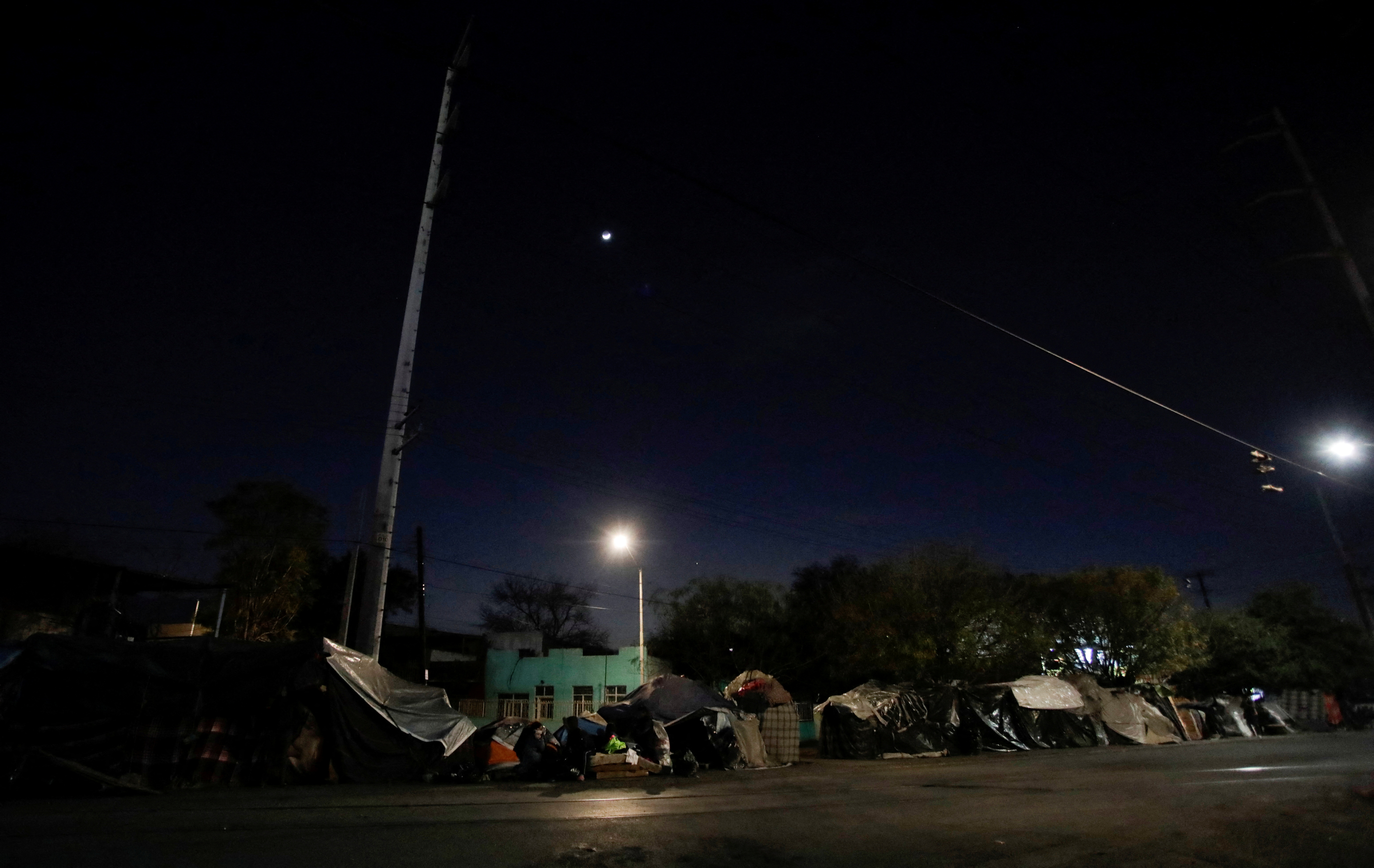 Migrants living in a makeshift camp outside a shelter, in Monterrey
