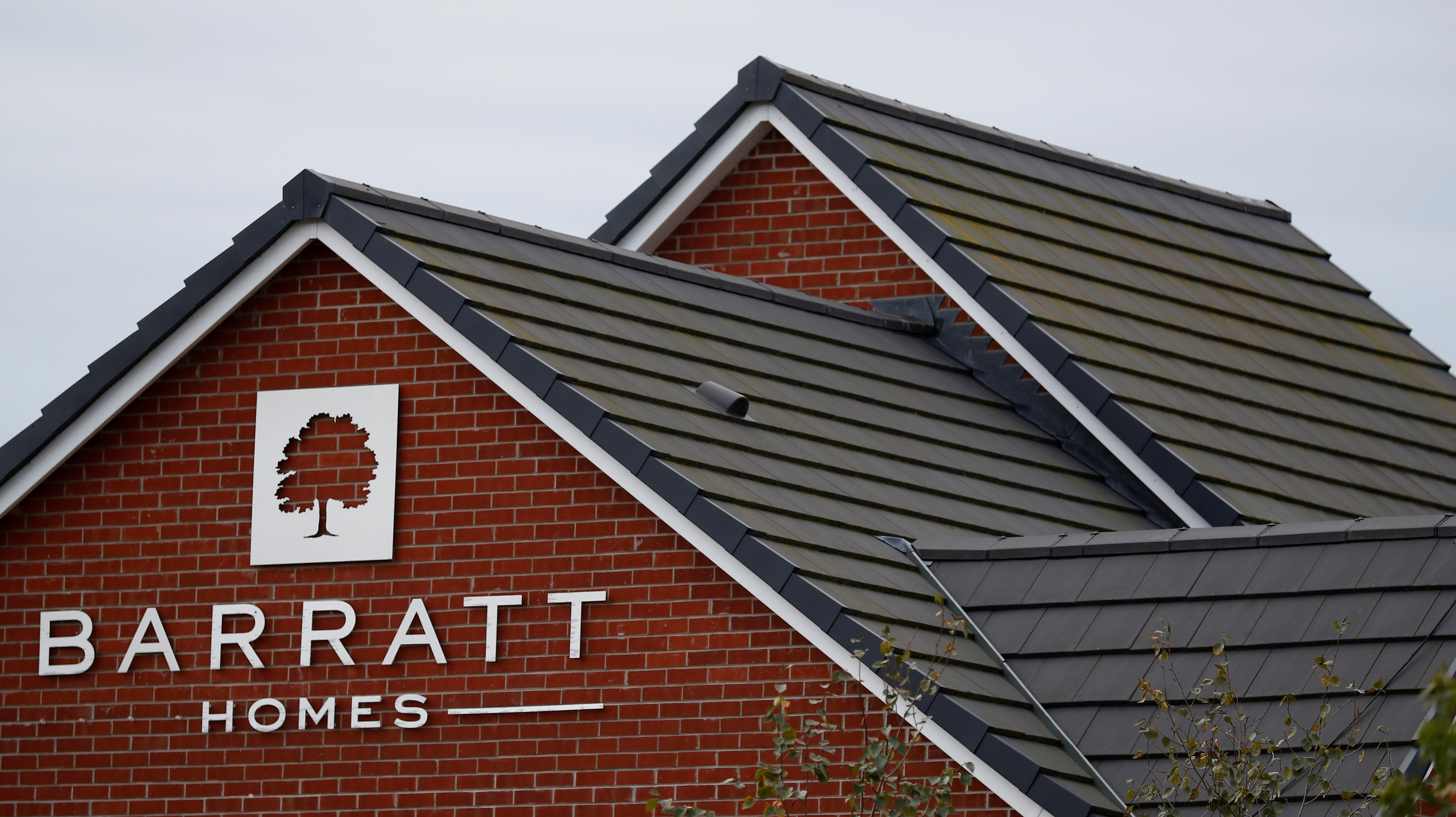 A company logo is seen on the side of a house at a Barratt Homes housing development near Preston