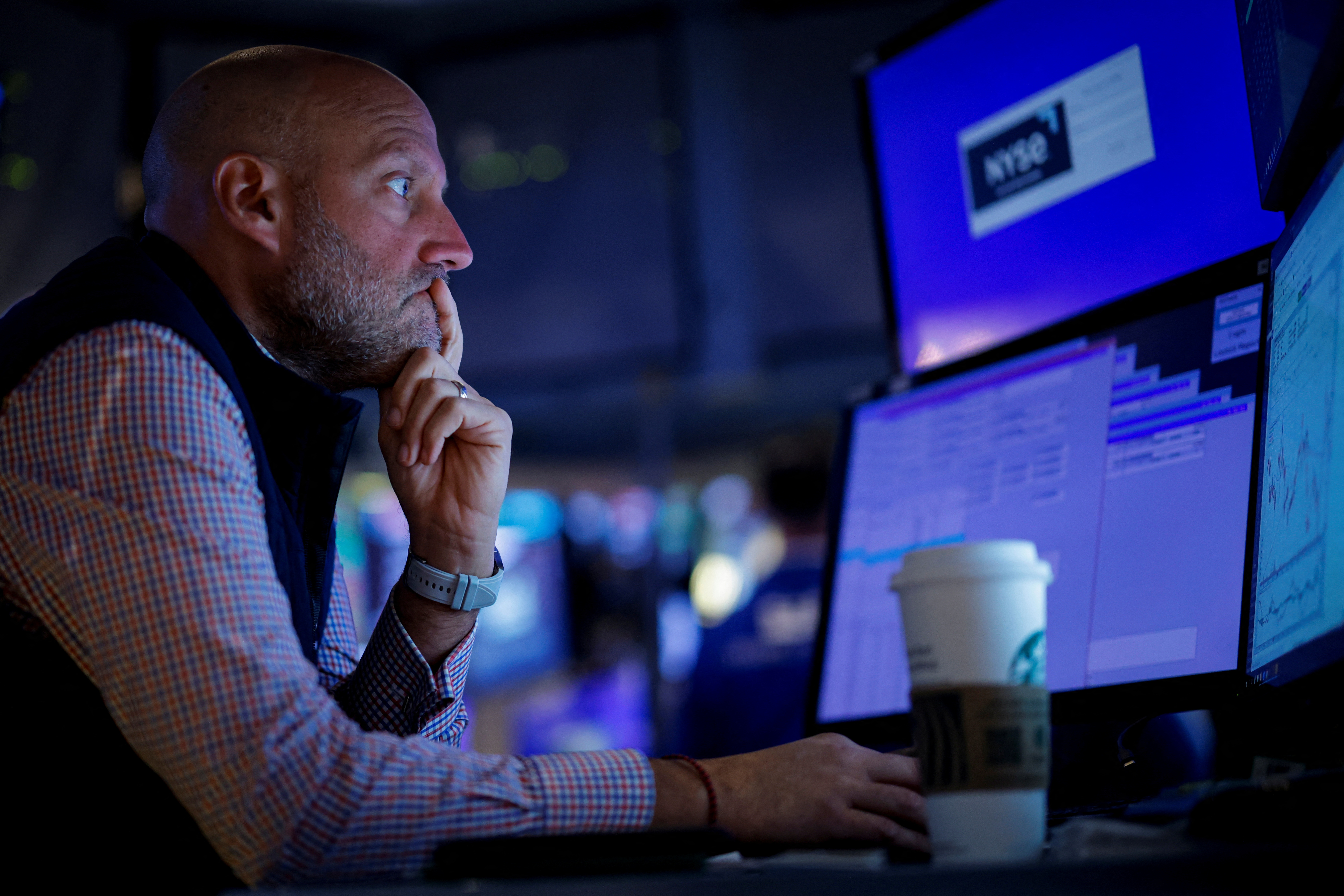 Traders work on the floor of the NYSE in New York