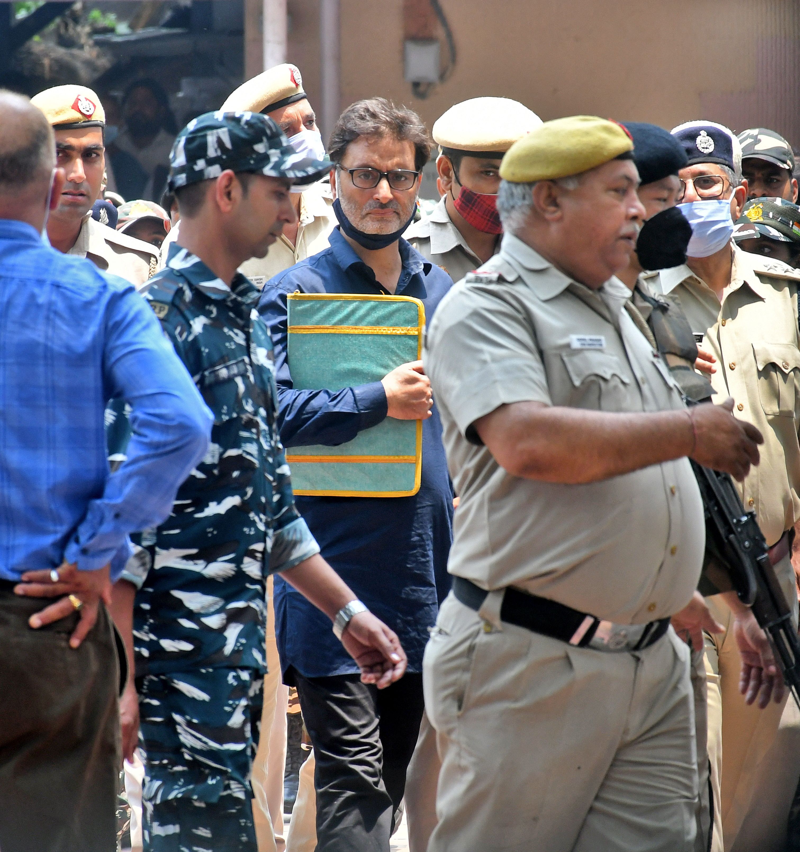 Yasin Malik is escorted by Indian police officers at a court premises in New Delhi
