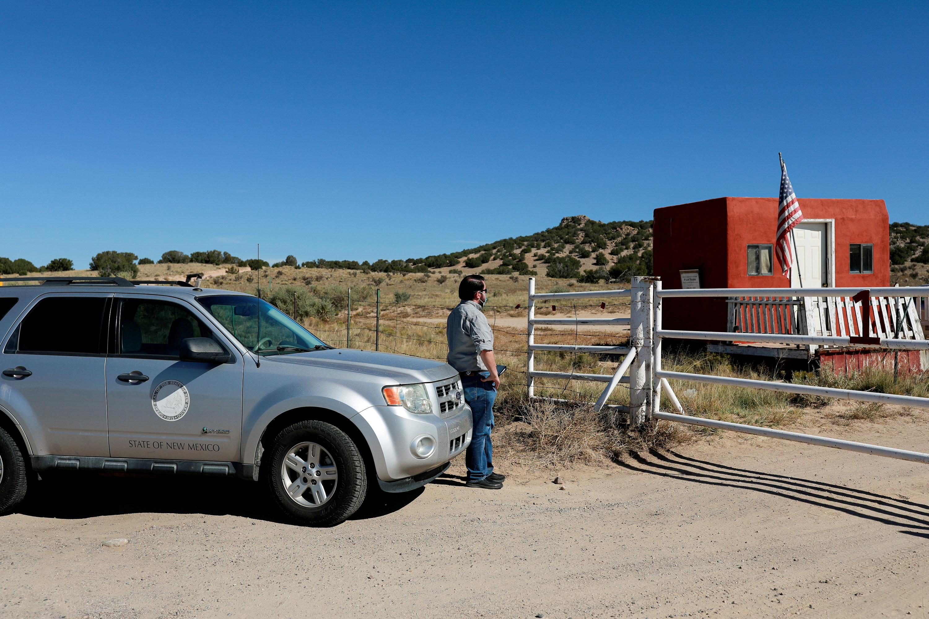 A compliance officer from the State of New Mexico waits to enter Bonanza Creek Ranch where on the film set of 