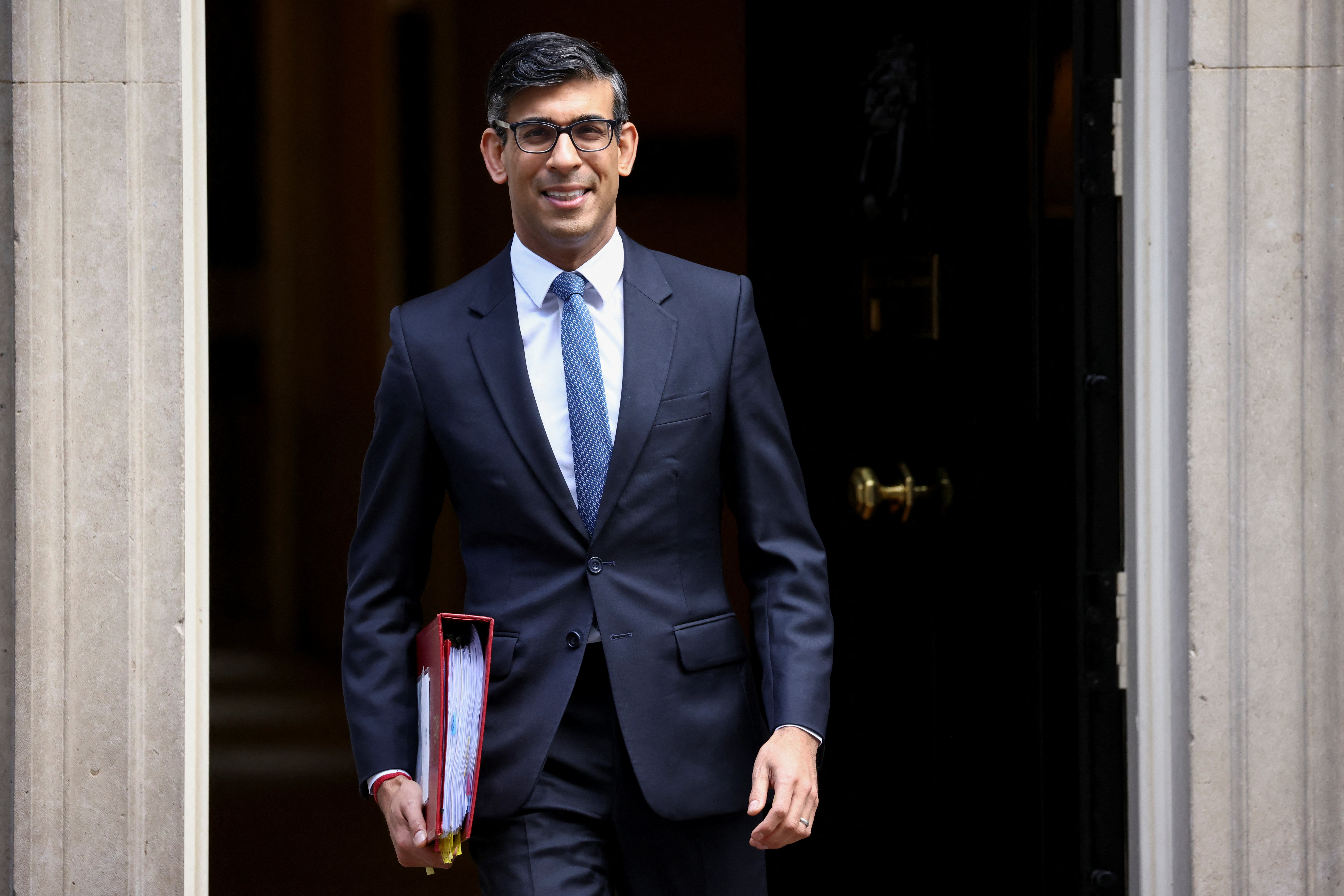 British Prime Minister Rishi Sunak walks on Downing Street in London
