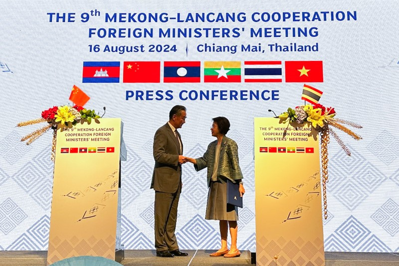 China's Foreign Minister Wang Yi shakes hand with Eksiri Pintaruchi, Permanent Secretary for Foreign Affairs of Thailand, during the 9th Mekong-Lancang Cooperation Foreign Ministers' Meeting in Chiang Mai