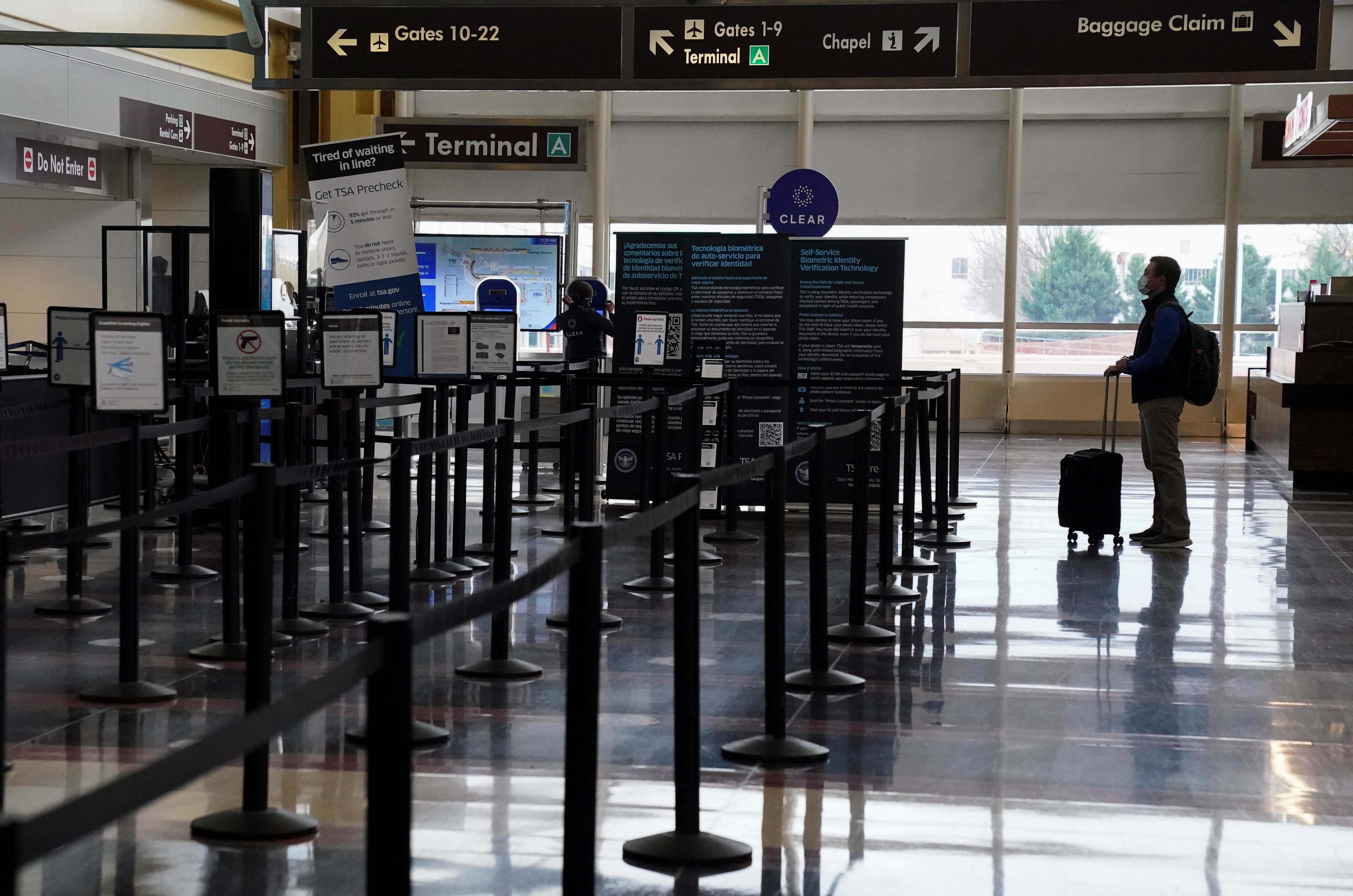 A traveler stands by a security gate at  Ronald Reagan Washington National Airport in Arlington, Virginia