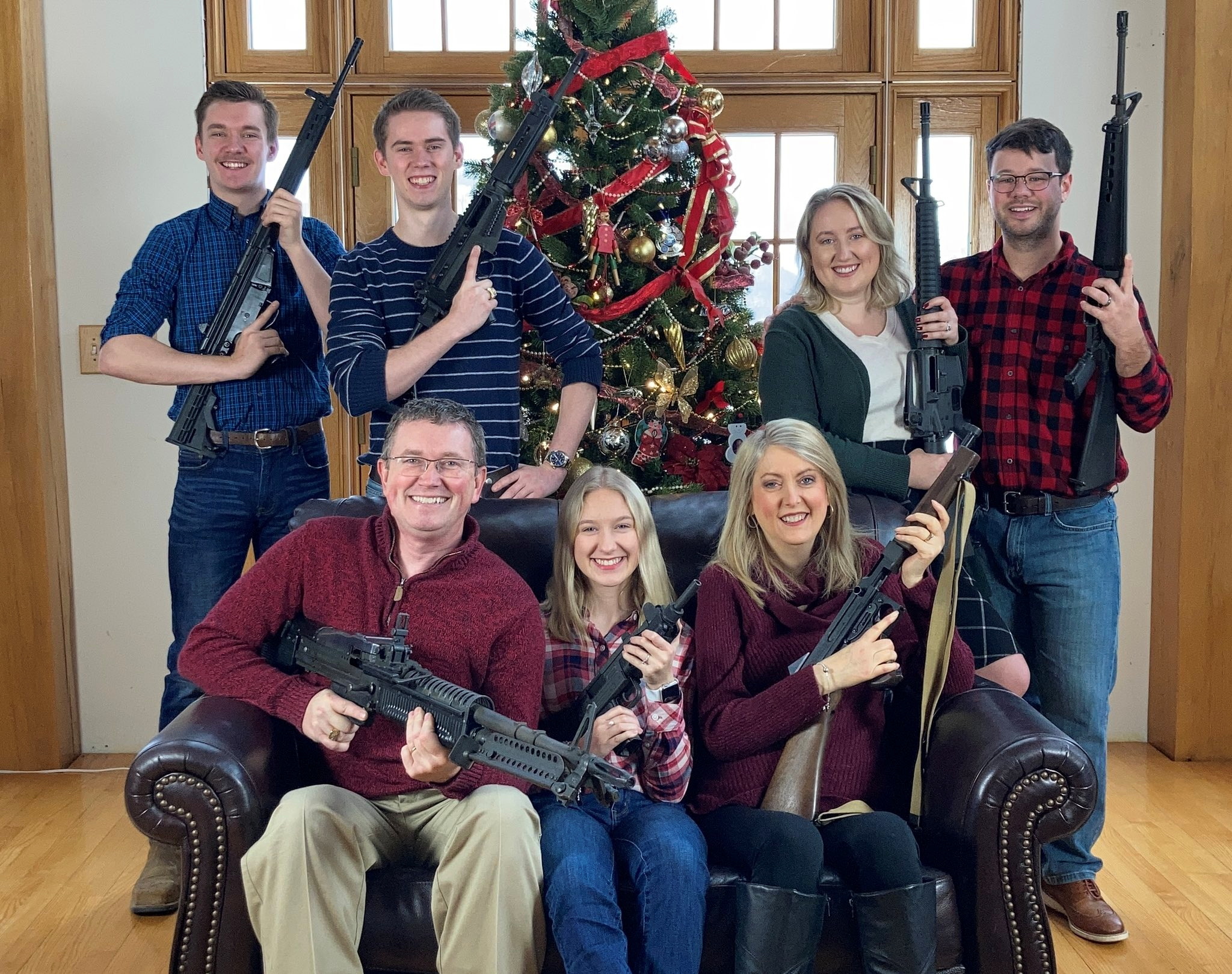 U.S. Rep. Thomas Massie (R-KY) in a Christmas photo of his family holding guns, in this image obtained from Twitter, posted on December 4, 2021. Courtesy of Twitter @REPTHOMASMASSIE / Social Media via REUTERS 