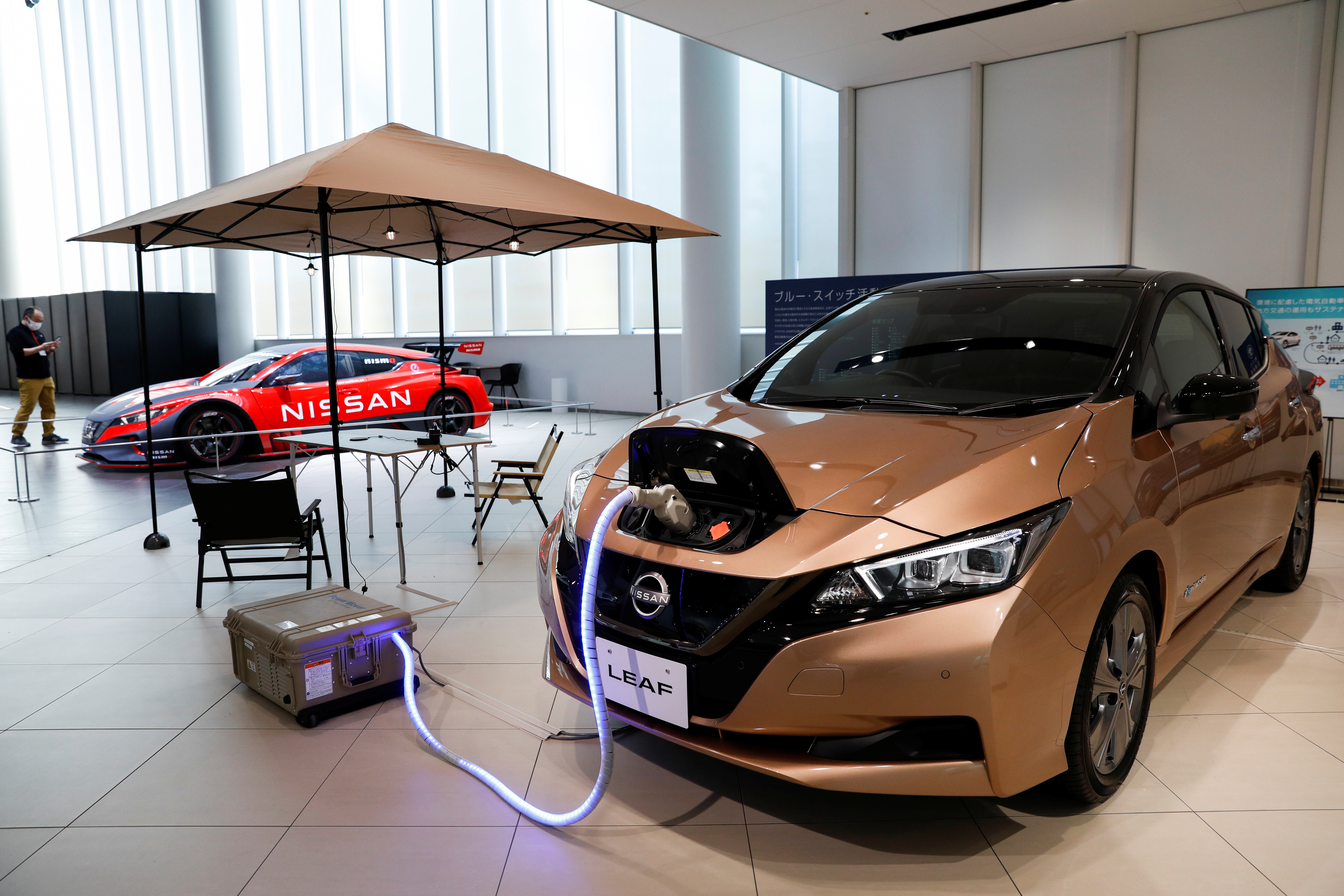 Leaf EV car and portable battery on display at Nissan Gallery in Yokohama