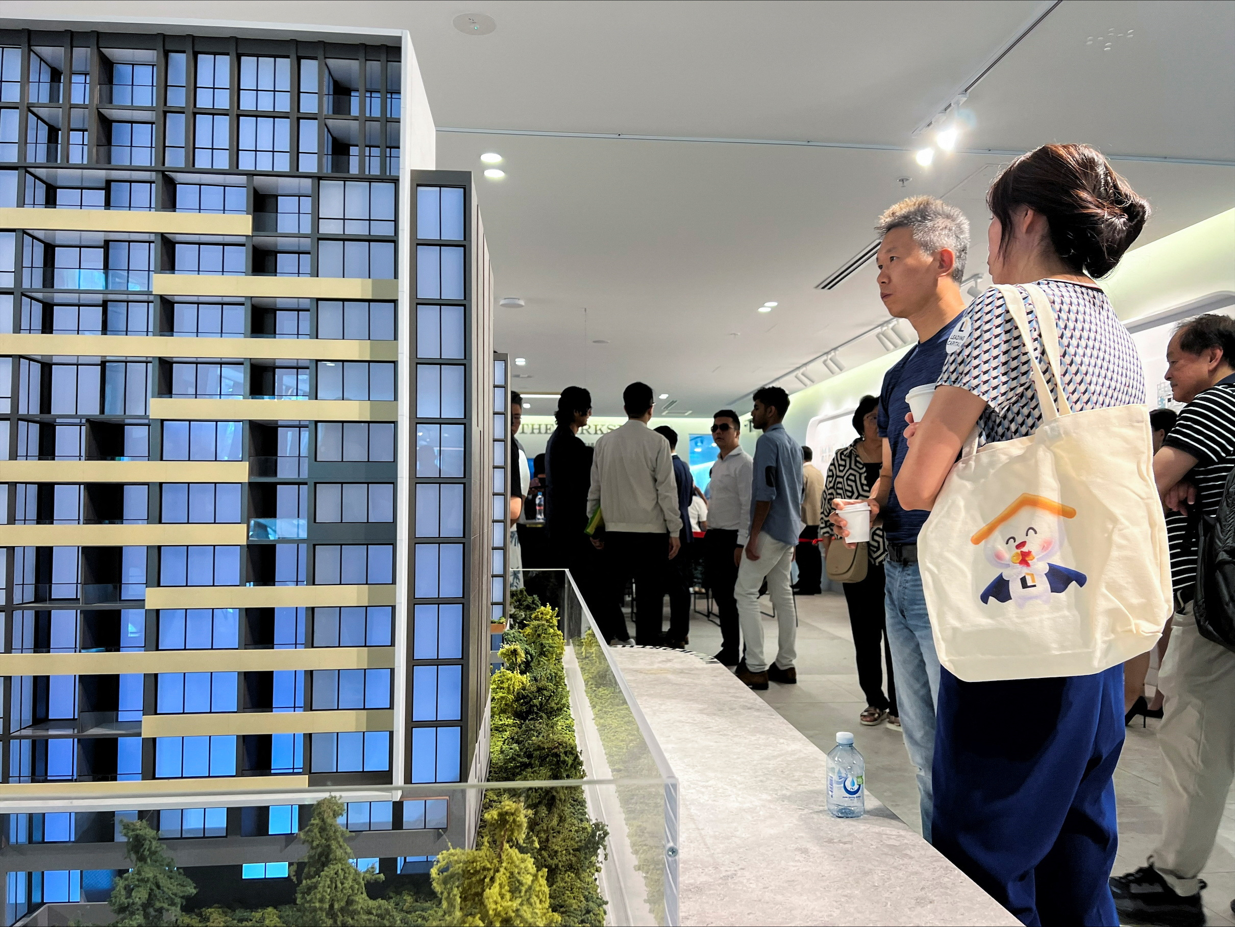 Two buyers look at models of apartments on sale at The Parkside, in Macquarie Park