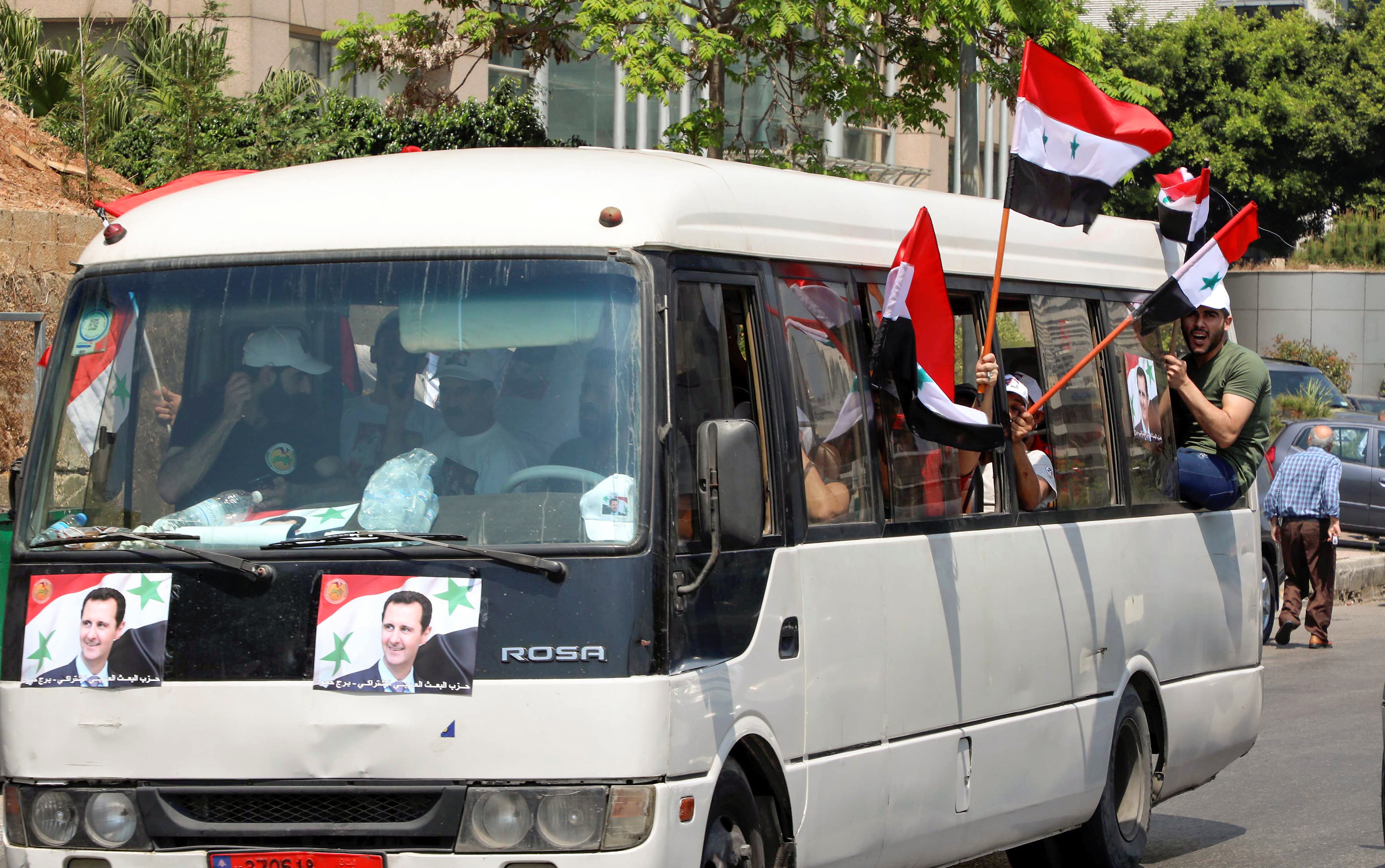 Pictures of Syrian President Bashar al Assad are seen on a bus in Beirut