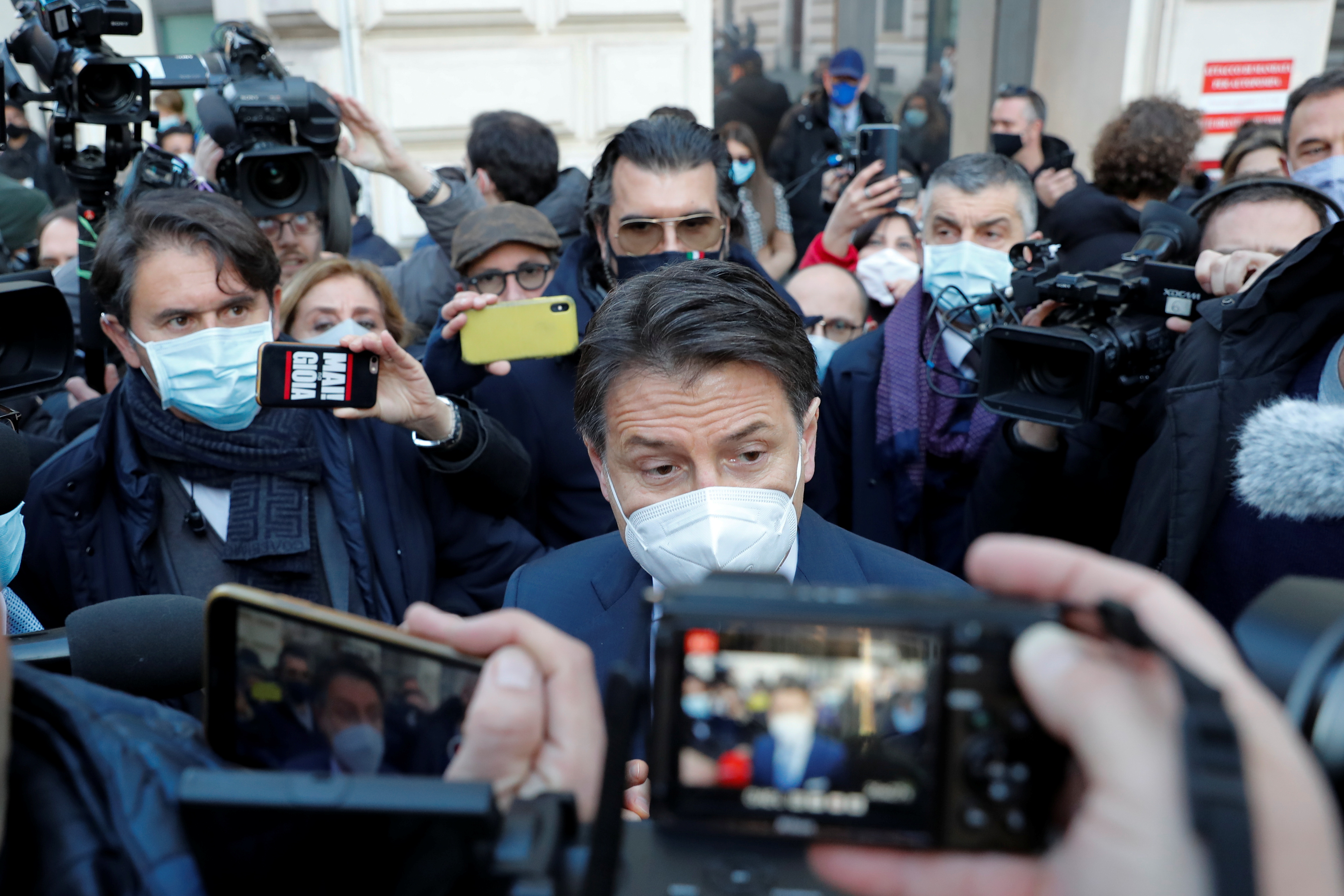 Italian Prime Minister Giuseppe Conte speaks to the media outside his office, Chigi Palace, after meeting with President Sergio Mattarella, in Rome, Italy, January 13, 2021. REUTERS/Remo Casilli