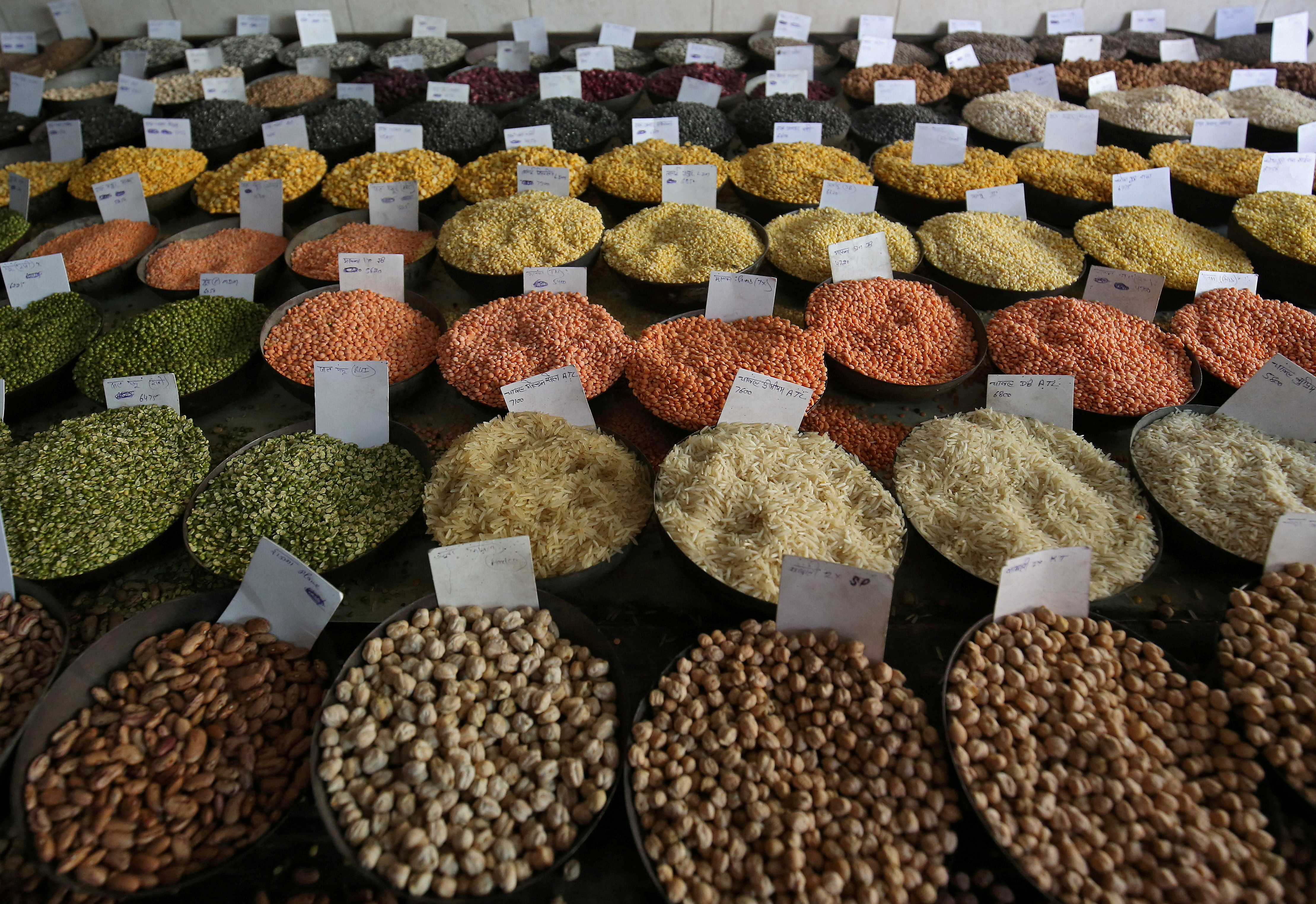 Price tags are seen on the samples of rice and lentils that are kept on display for sale at a wholesale market in the old quarters of Delhi