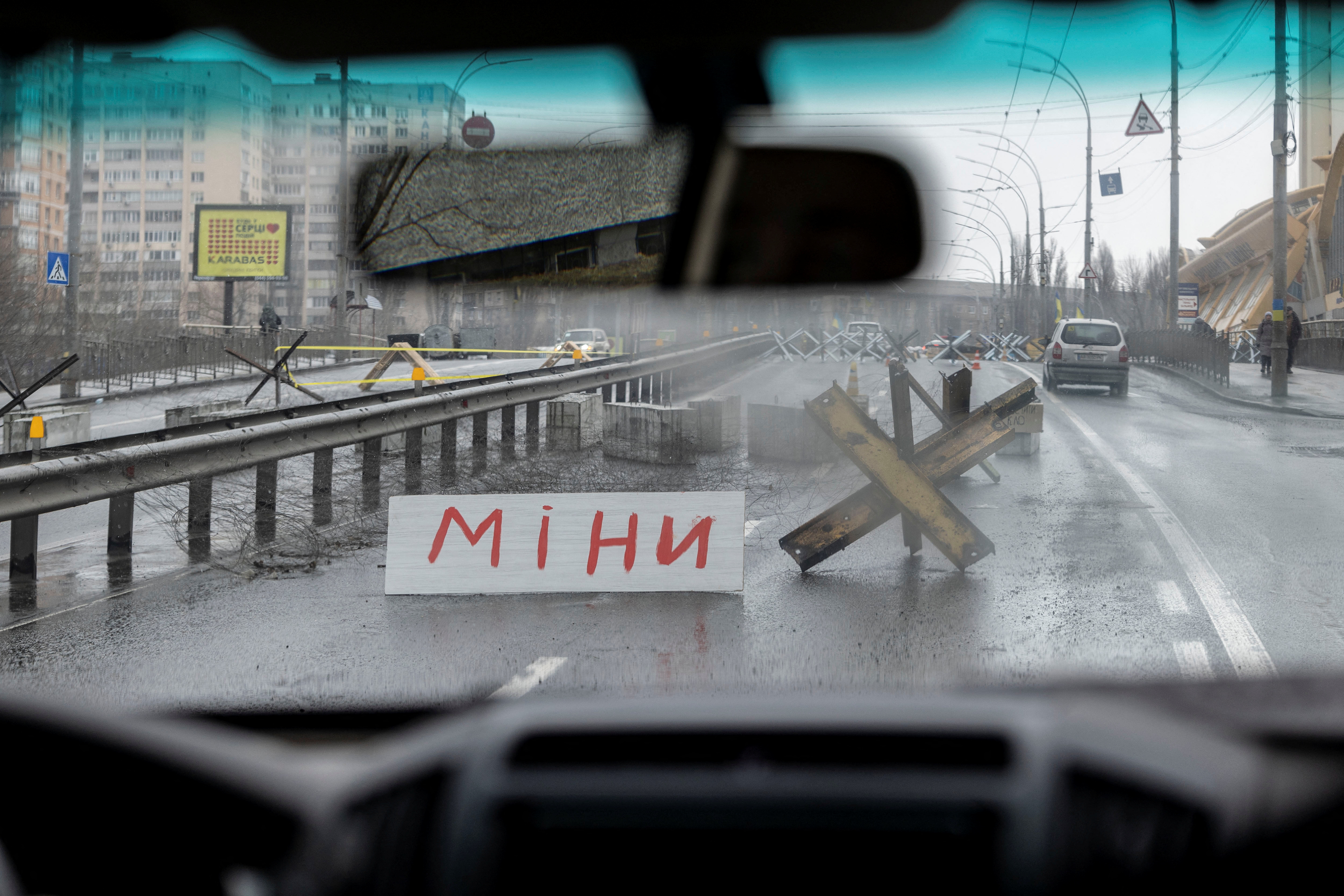 A sign in Ukrainian which reads “Mine” is seen at a roadblock as Russia's invasion of Ukraine continues, in Kyiv, Ukraine