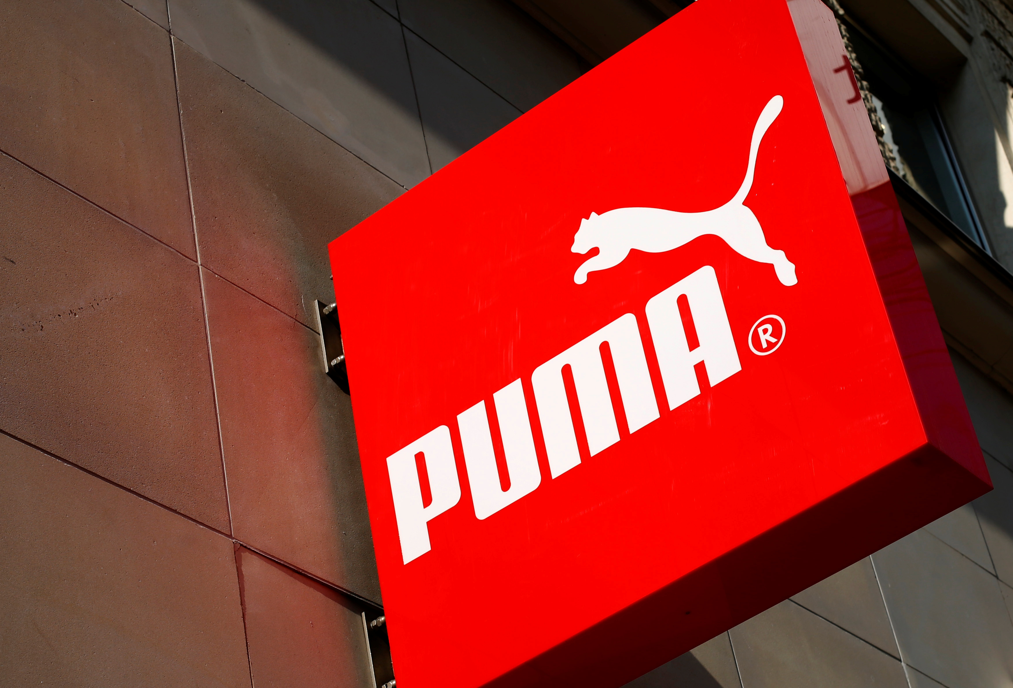The logo of German sports goods firm Puma is seen at the entrance of one of its stores in Vienna