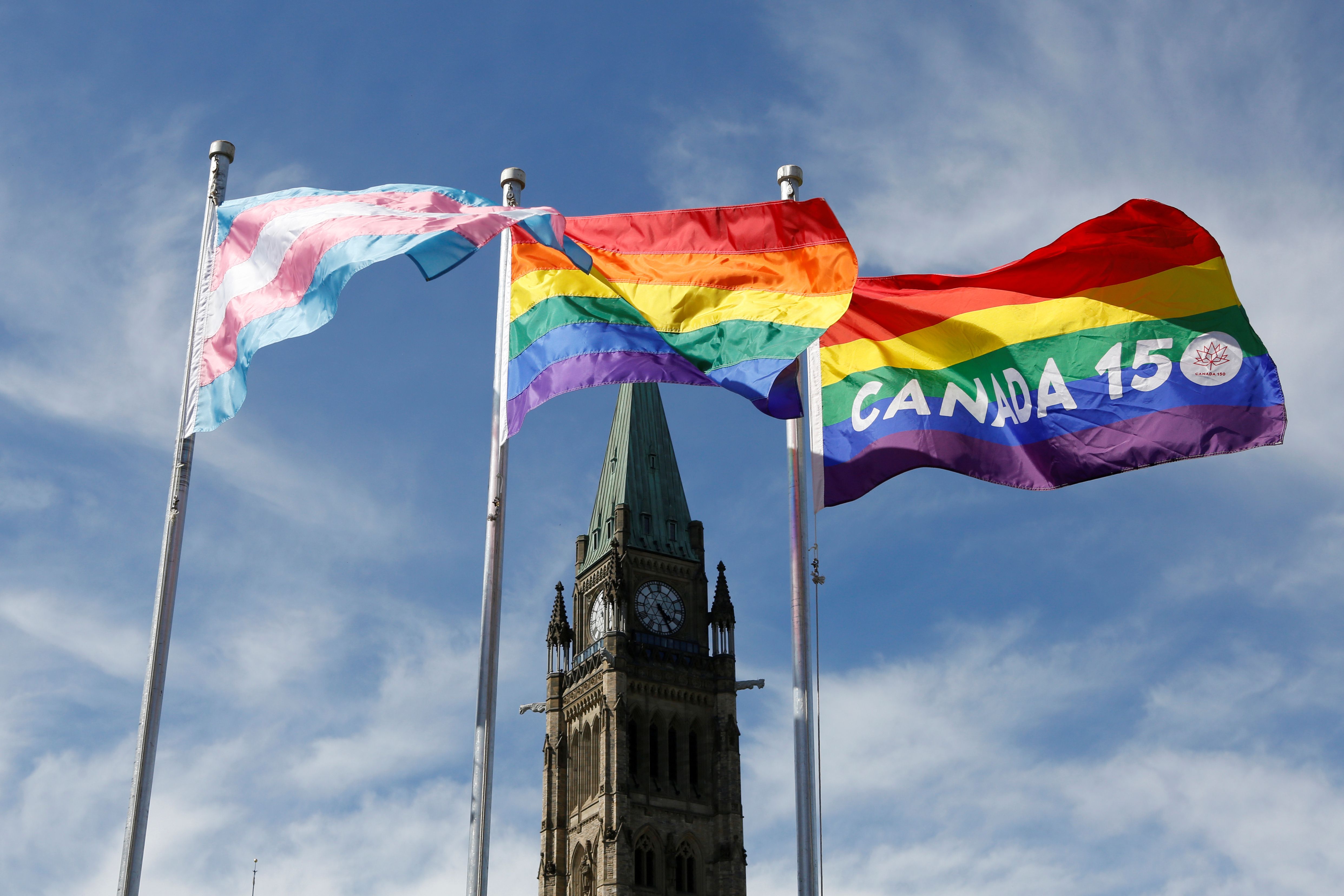 The transgender pride, pride and Canada 150 pride flags fly on Parliament Hill in Ottawa