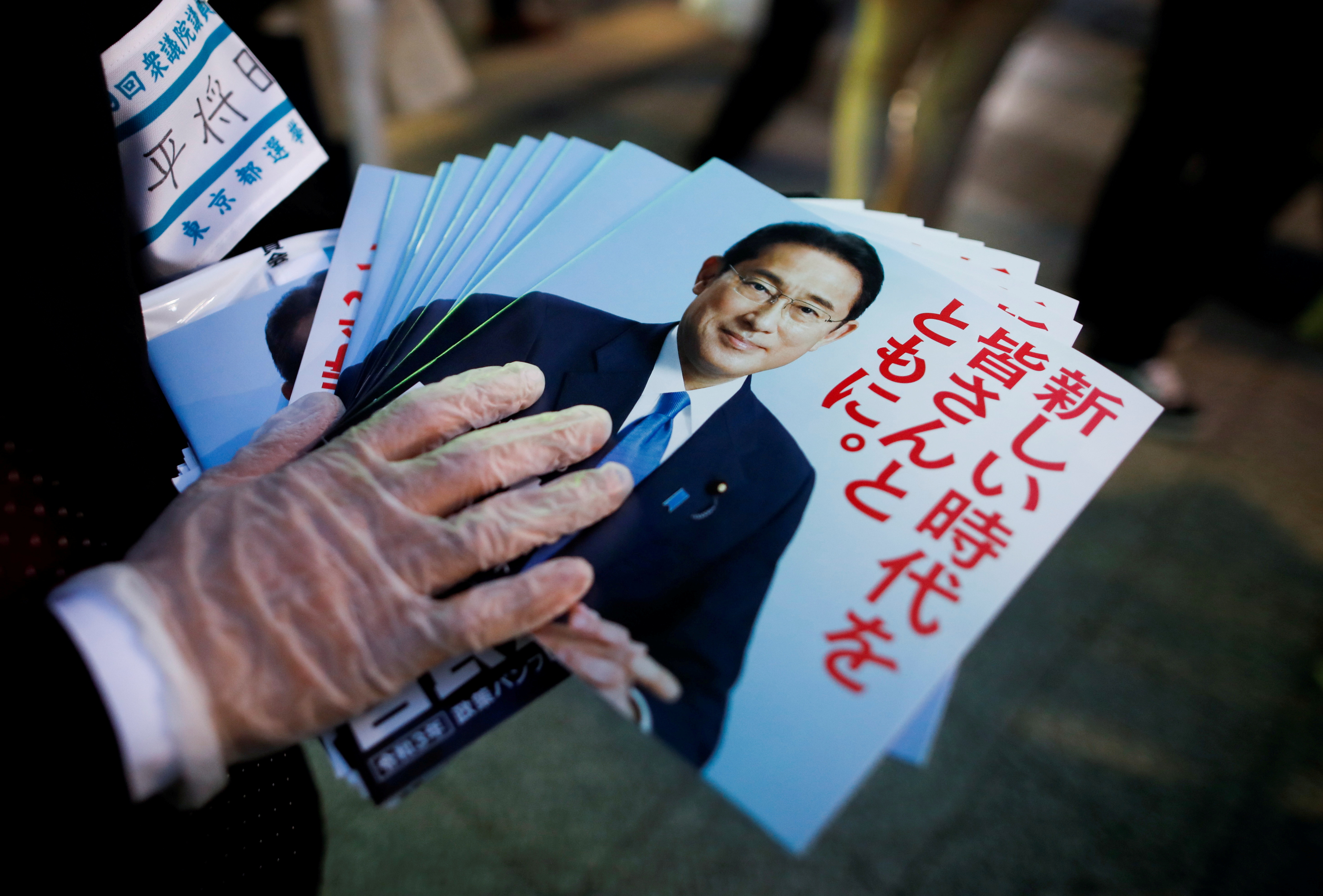 An election campaign staff member holds leaflets of Japan's ruling Liberal Democratic Party during an election campaign for the upcoming lower house election in Tokyo