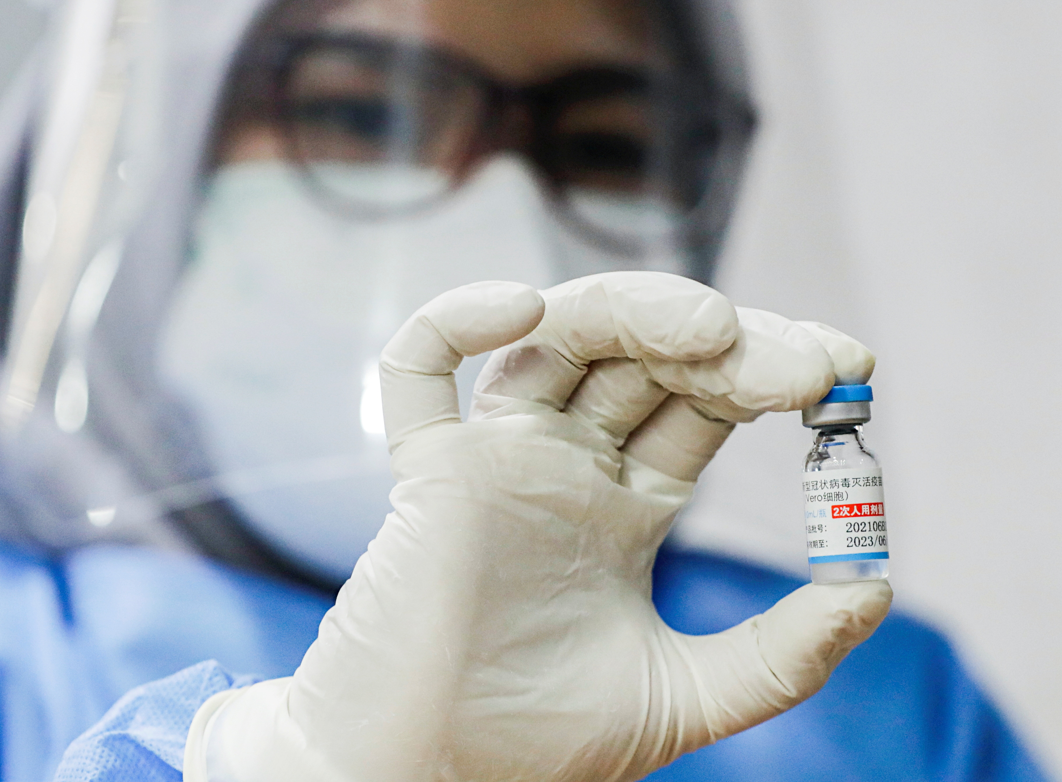 A healthcare worker shows a dose of Sinopharm vaccine against the coronavirus disease (COVID-19) during a mass vaccination program for foreigners in Jakarta, Indonesia, August 24, 2021. REUTERS/Ajeng Dinar Ulfiana/File Photo