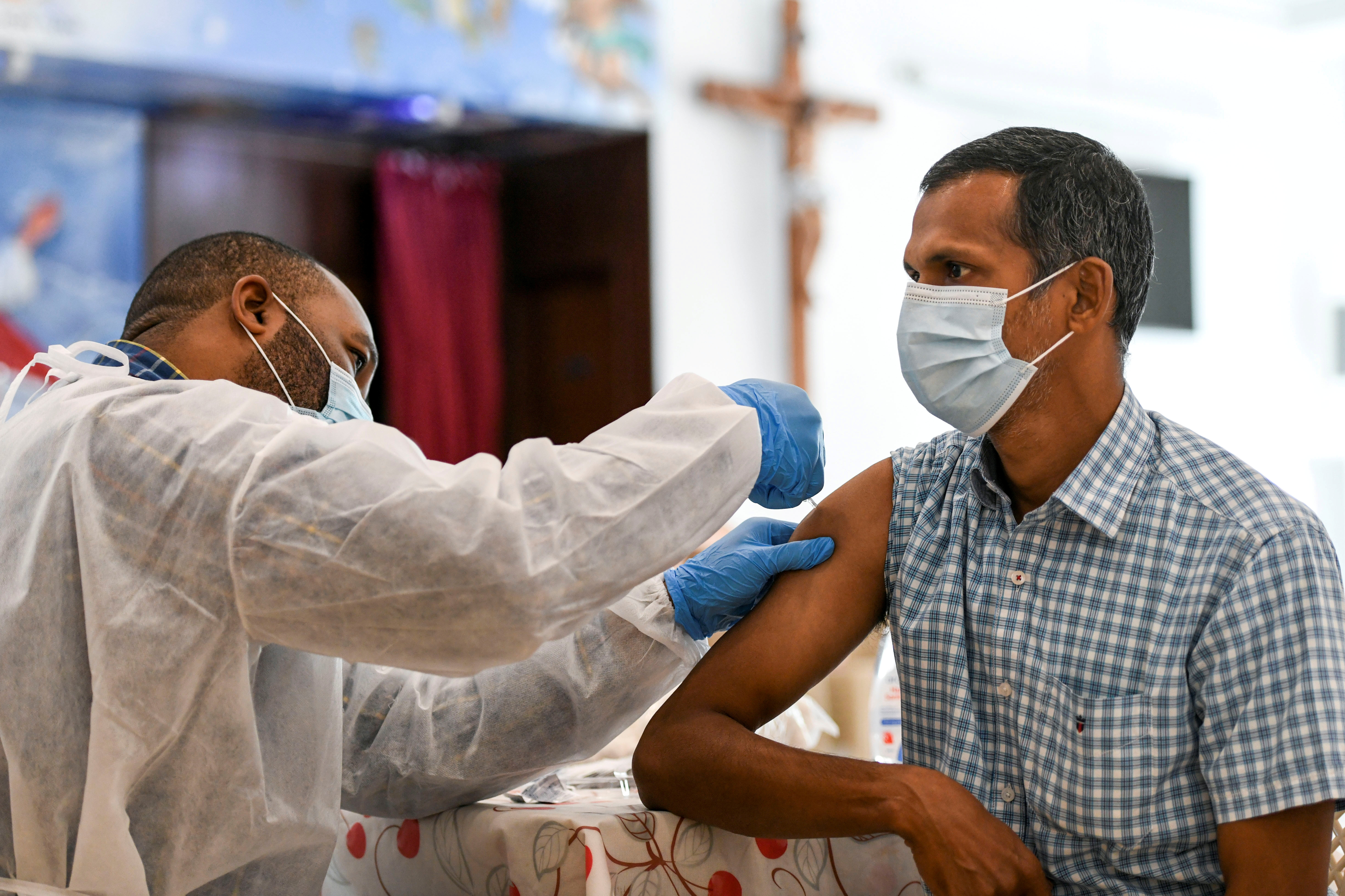 A man receives a dose of a vaccine against the coronavirus disease (COVID-19)at St. Paul's Church in Abu Dhabi