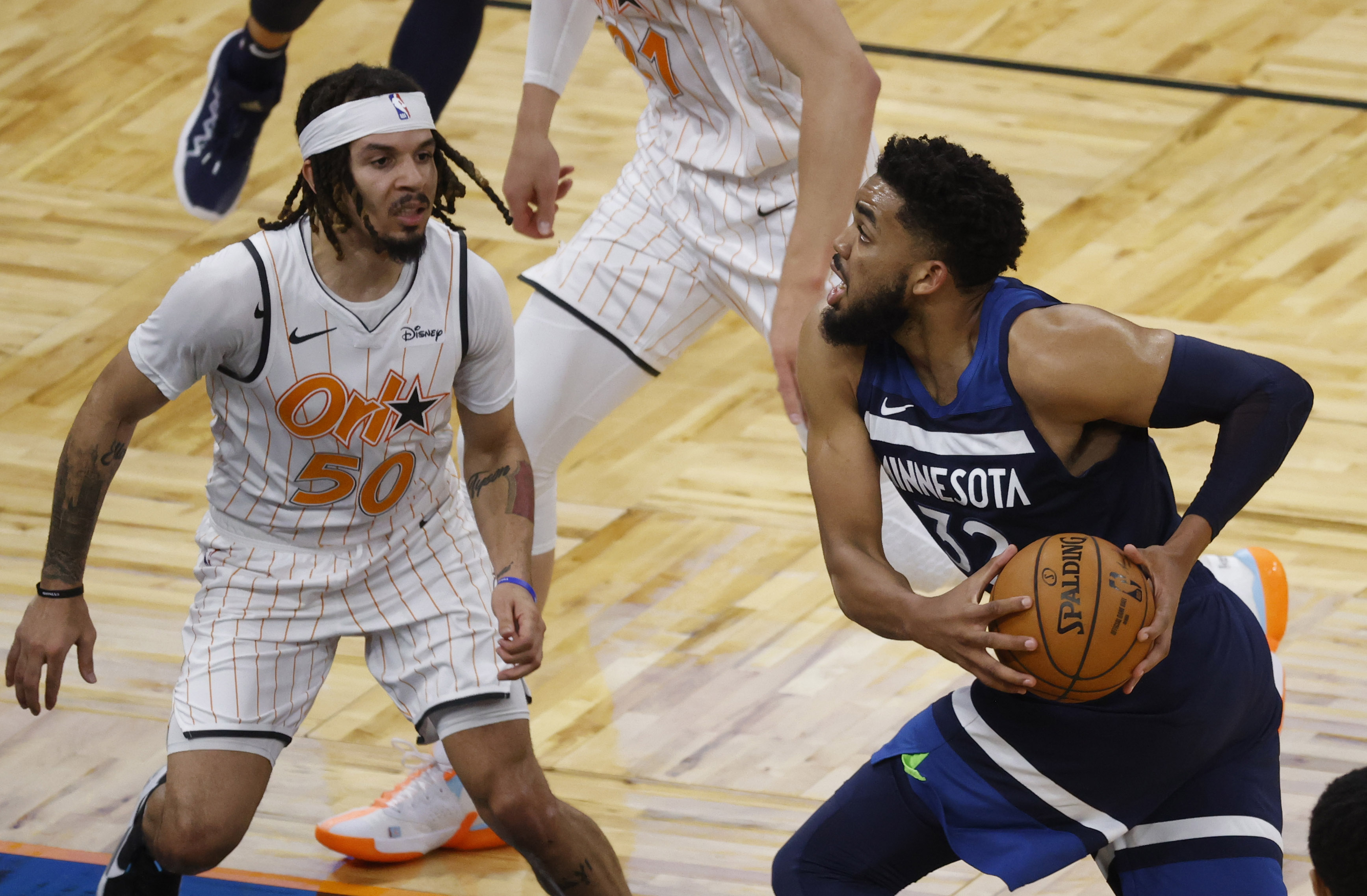 May 9, 2021; Orlando, Florida, USA; Minnesota Timberwolves center Karl-Anthony Towns (32) drives to the basket as Orlando Magic guard Cole Anthony (50) defends during the second half at Amway Center. Mandatory Credit: Kim Klement-USA TODAY Sports