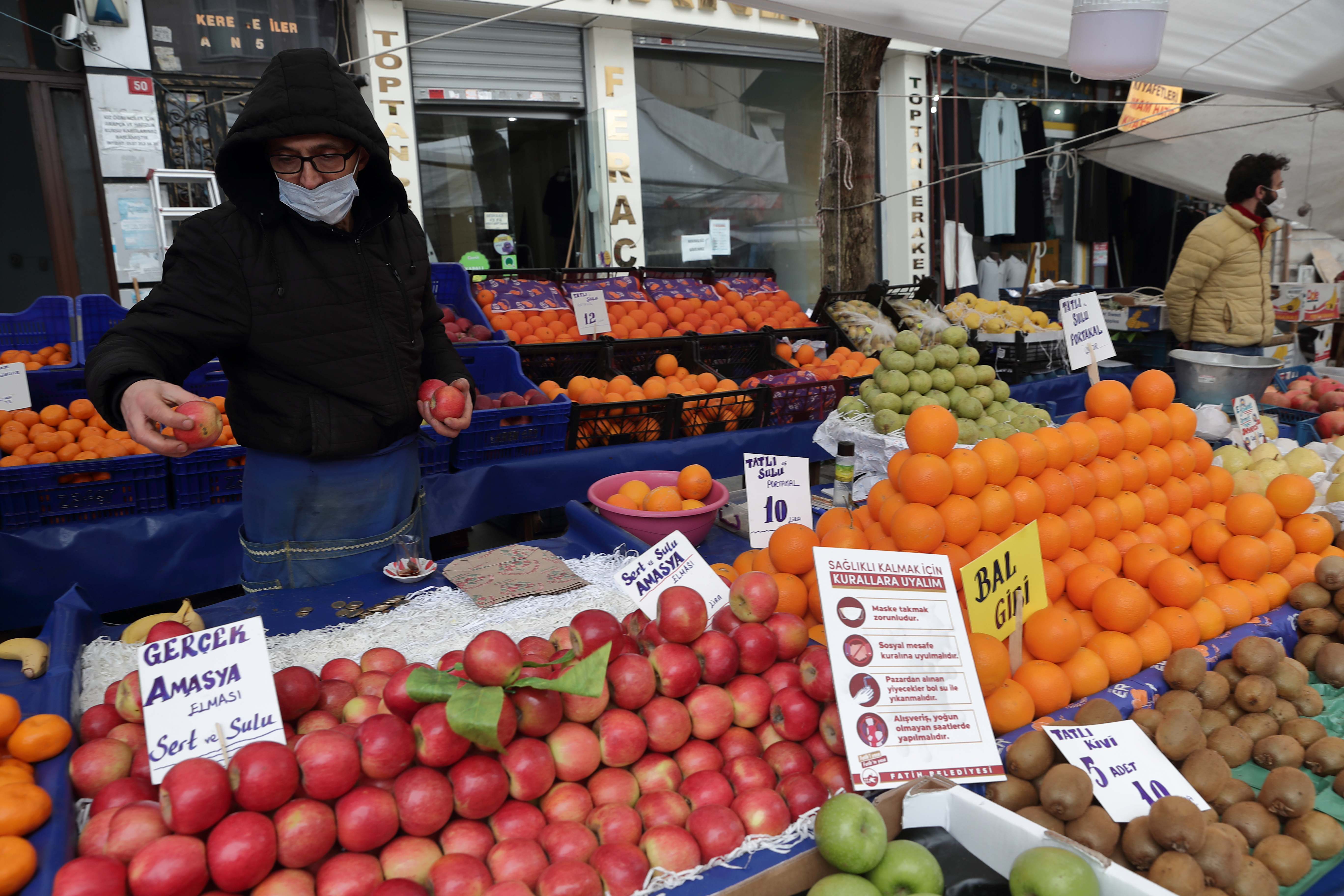 Seref Geyik waits for customers at his stall at a local market in Fatih district in Istanbul