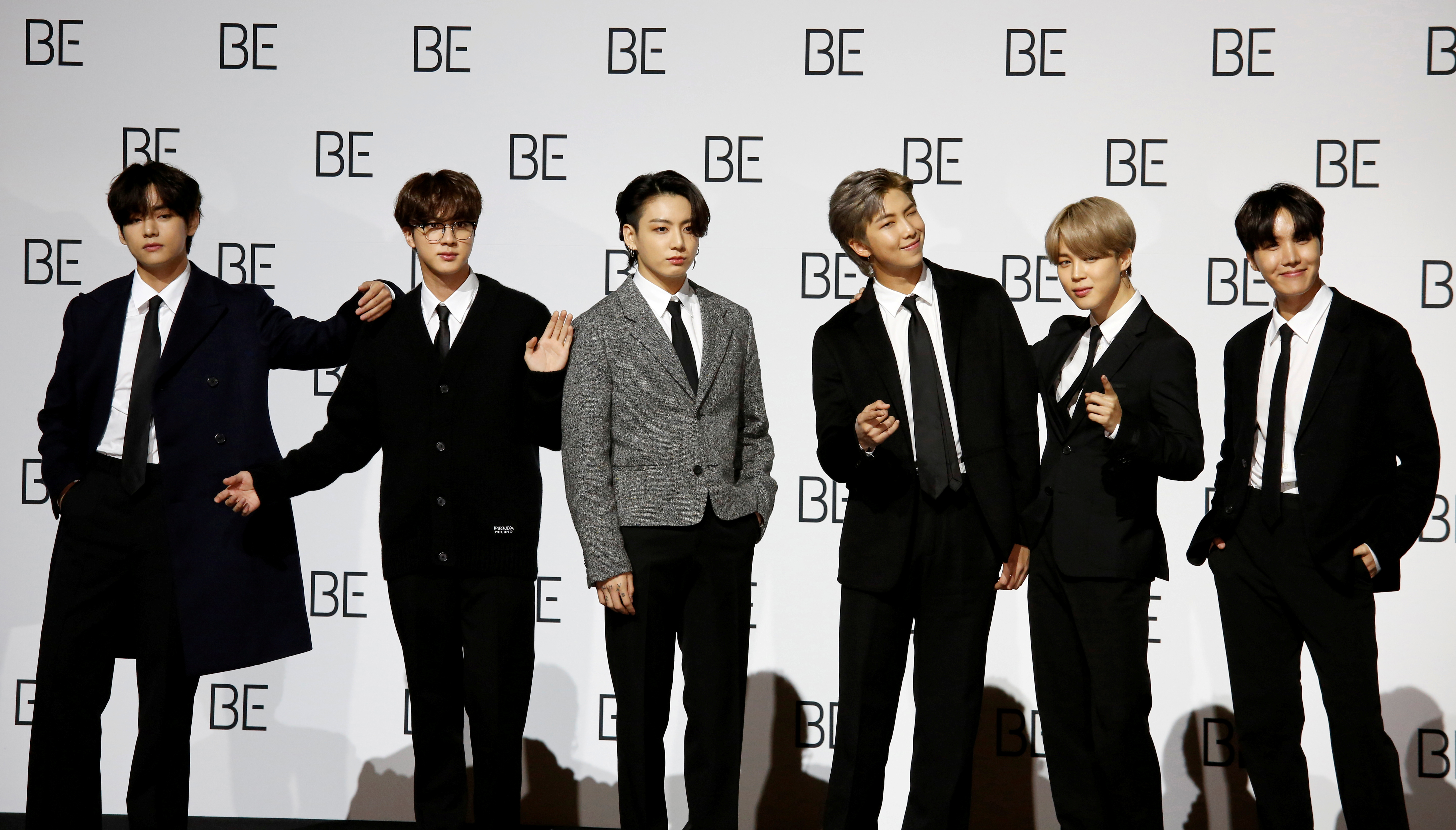 Members of K-pop boy band BTS pose for photographs during a news conference promoting their new album 