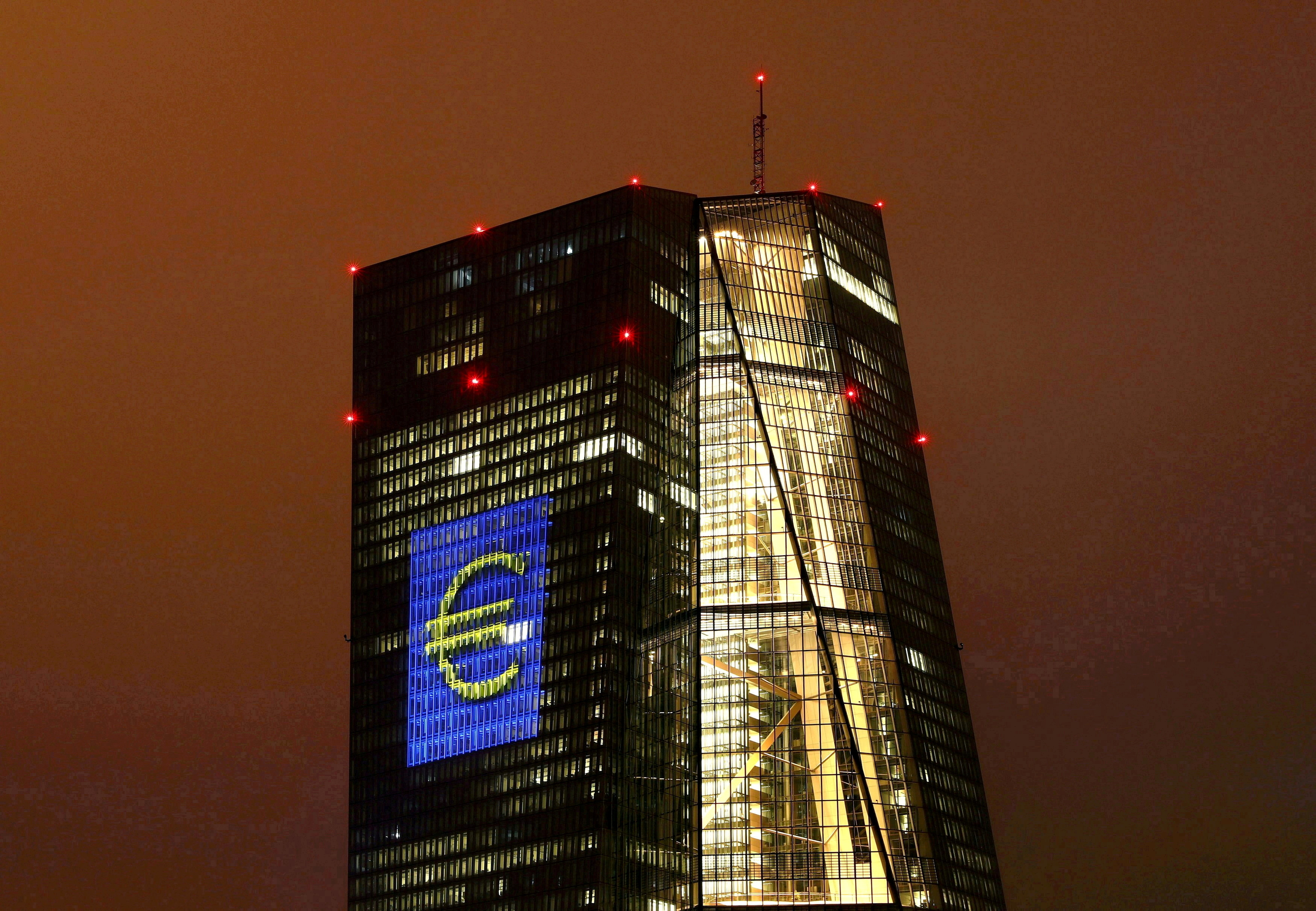 Headquarters of the European Central Bank (ECB) are illuminated with a giant euro sign at the start of the 