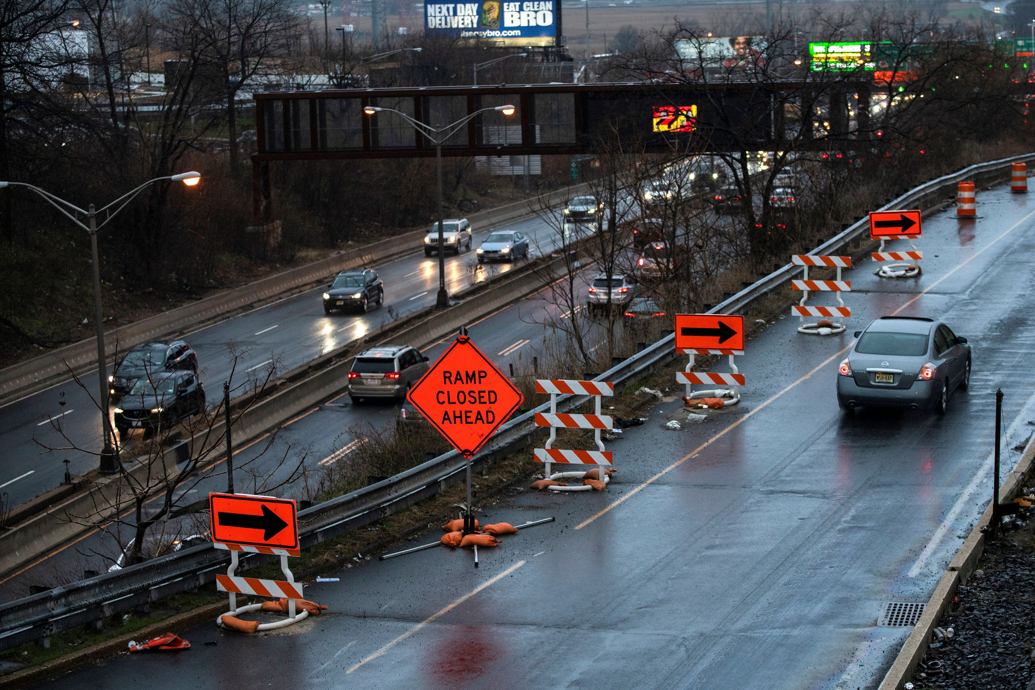 Cars drive along the NJ 495 route while road work signs are seen on the roadside, in Union City, New Jersey, U.S. March 31, 2021. REUTERS/Eduardo Munoz