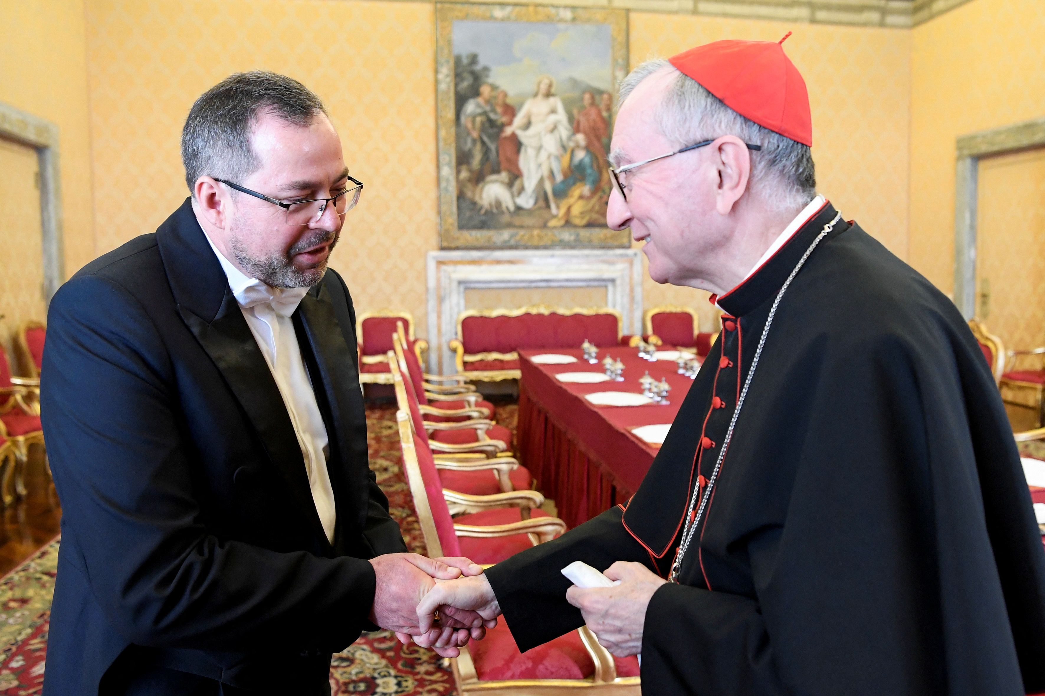 Vatican's Secretary of State, Cardinal Pietro Parolin shakes hand with Ukraine's ambassador to the Vatican, Andriy Yurash during a private audience at the Vatican