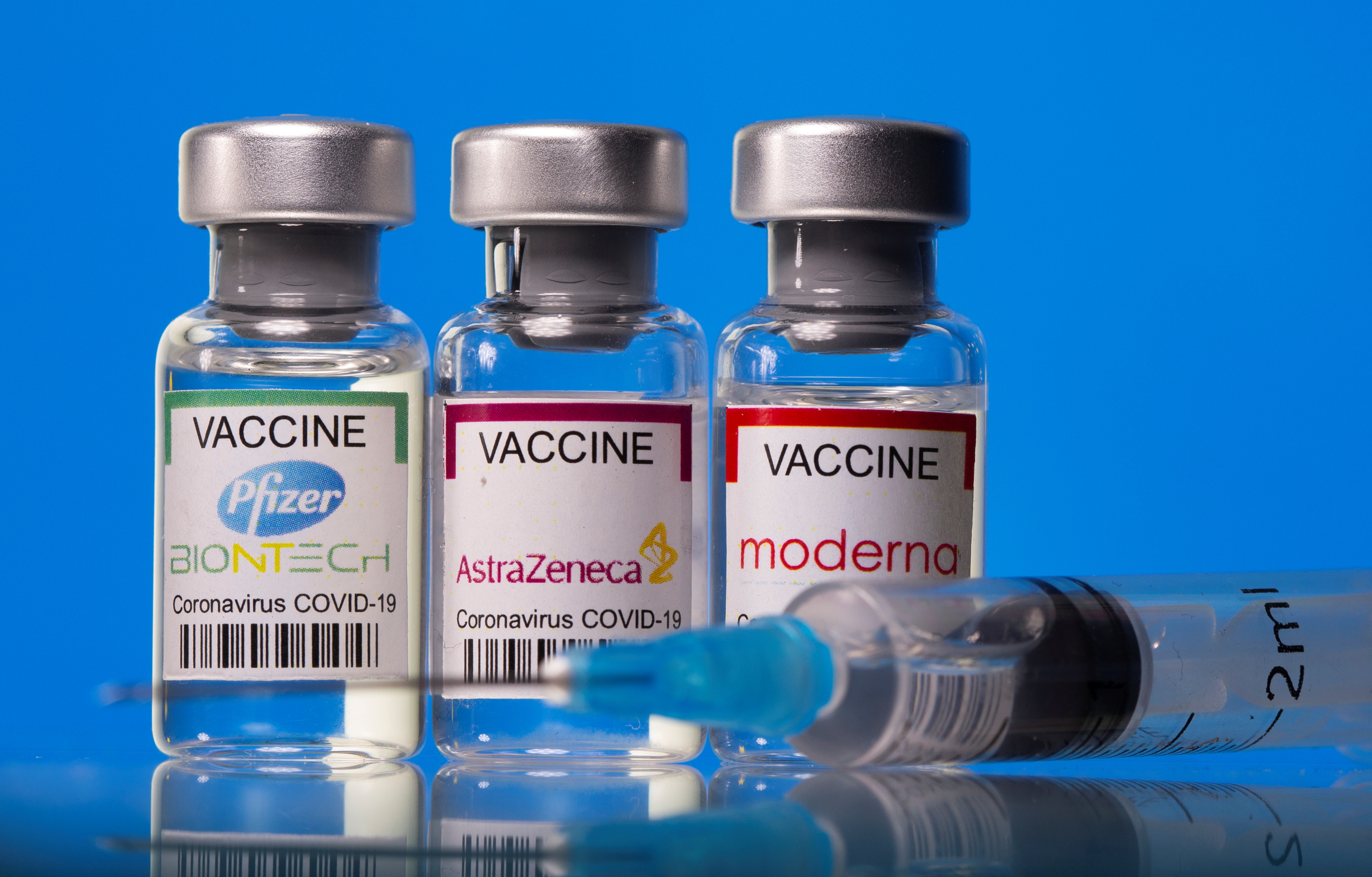 Vials with Pfizer-BioNTech, AstraZeneca, and Moderna coronavirus disease (COVID-19) vaccine labels are seen in this illustration picture taken March 19, 2021. REUTERS/Dado Ruvic/Illustration