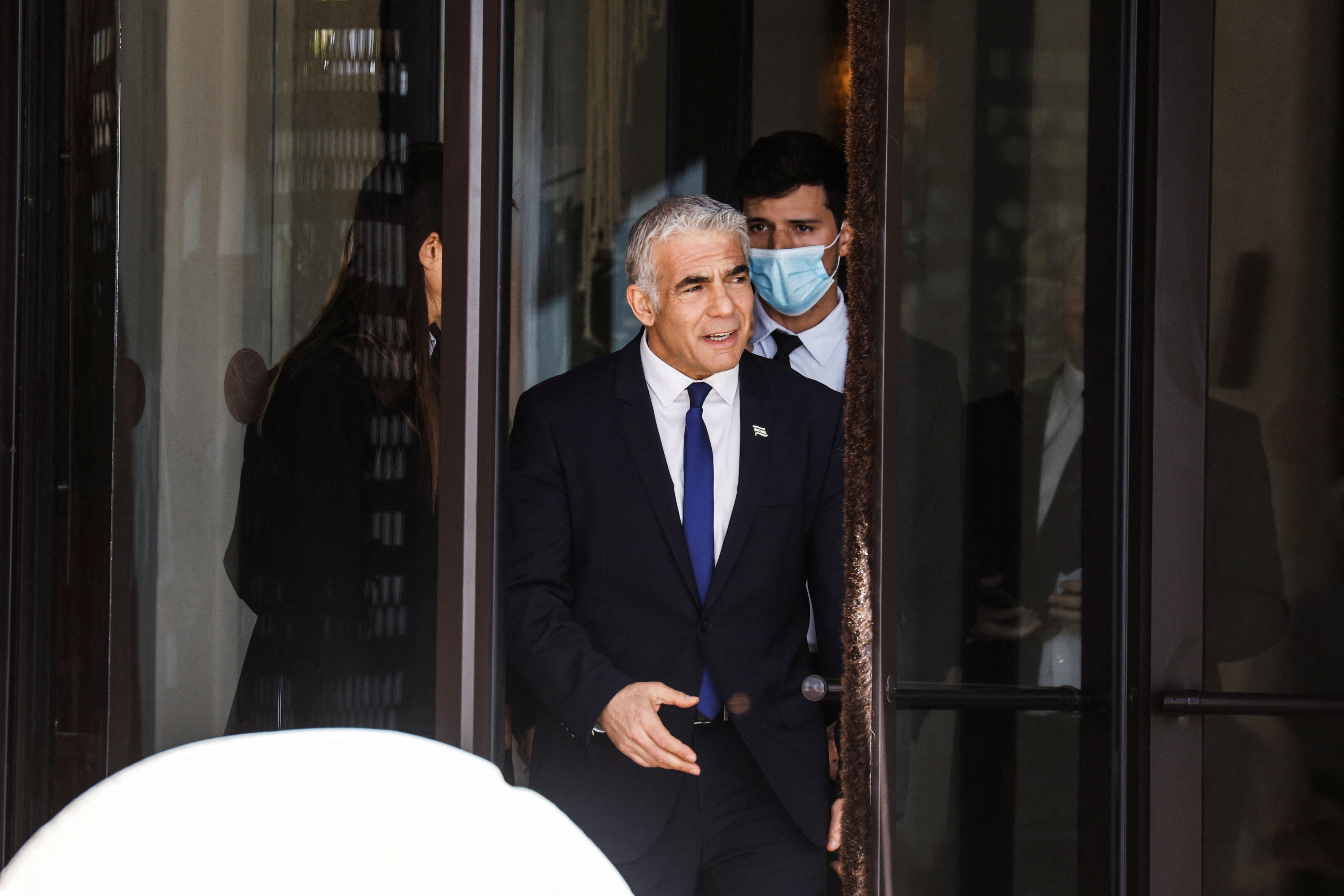 Israel's Foreign Minister Yair Lapid departs the Kedma Hotel, the location of 