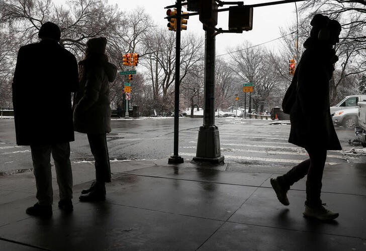 People make their way through snow during a winter storm in New York