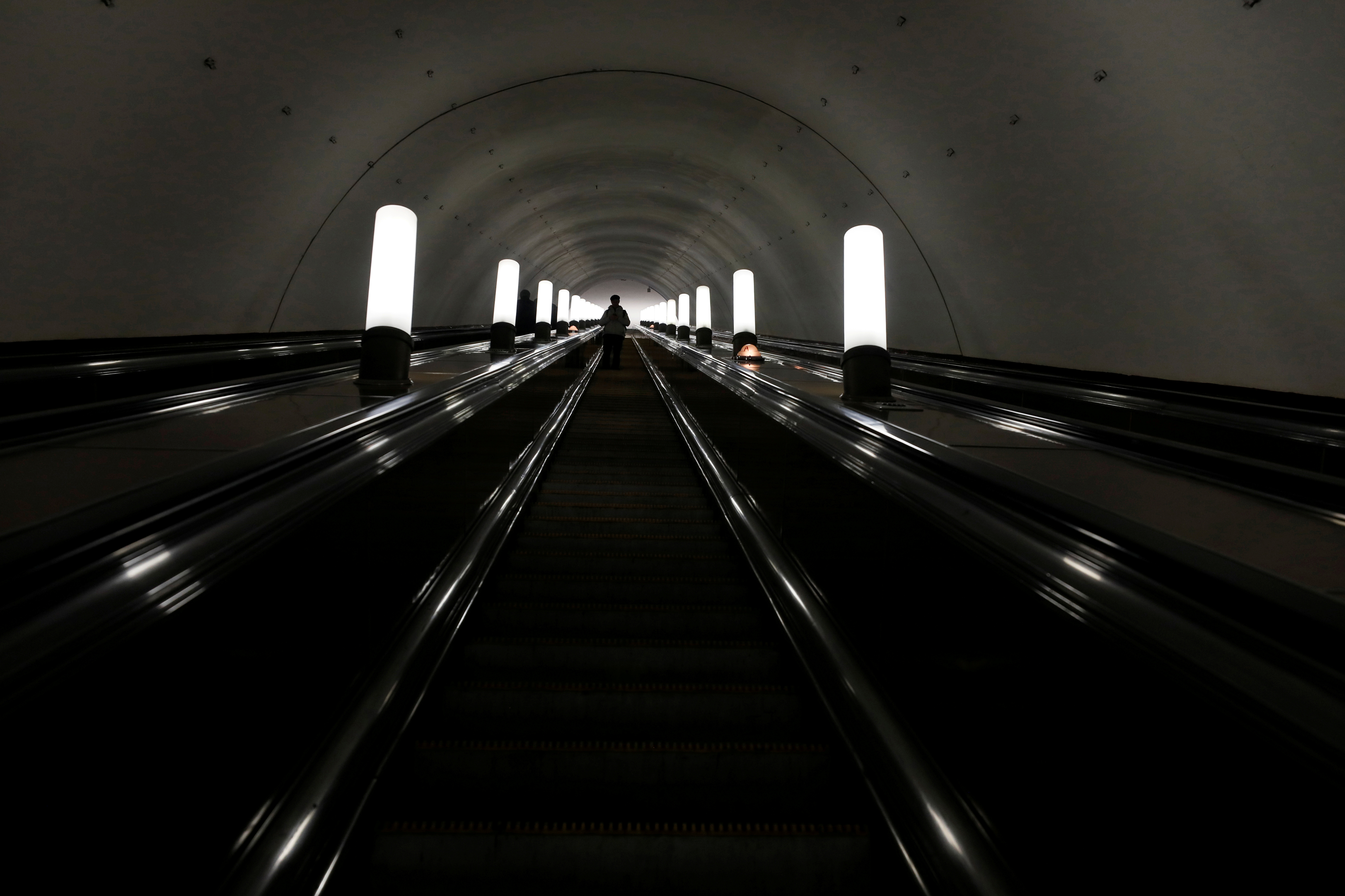 A passenger rides an escalator at a metro station in Moscow
