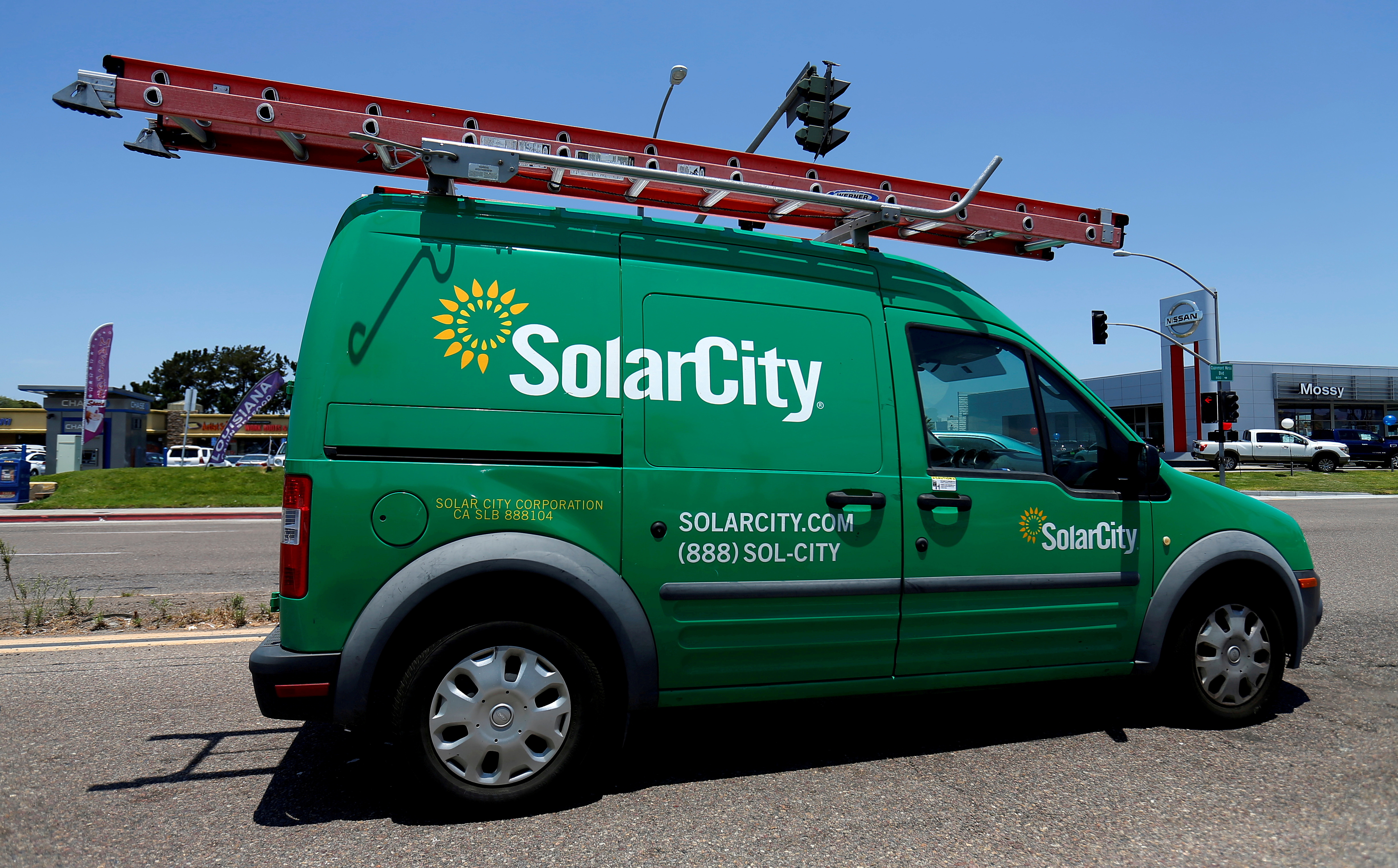 A SolarCity vehicle is seen on the road in San Diego, California, U.S. June 22, 2016.        REUTERS/Mike Blake/File Photo