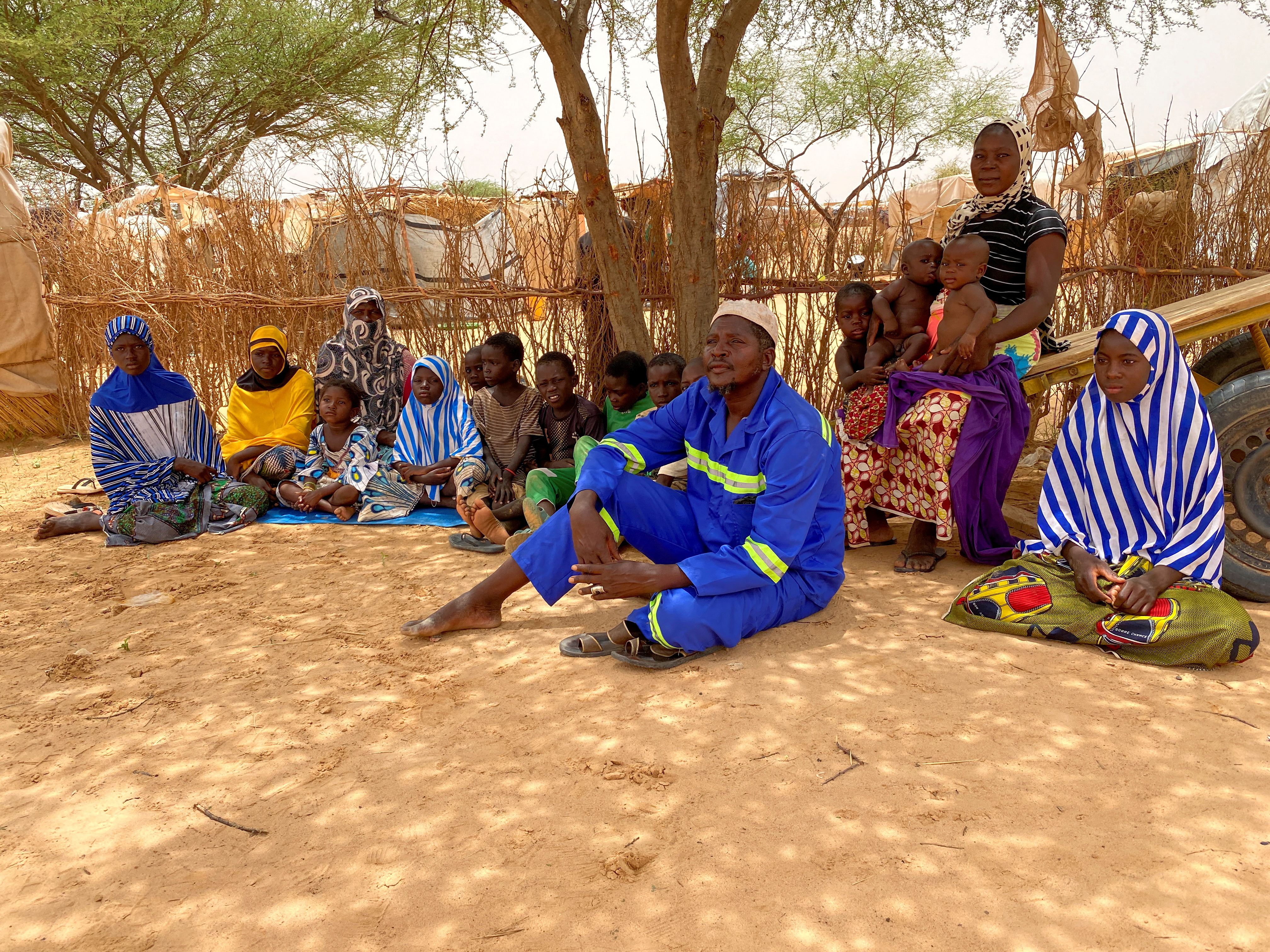 Residents of the Nigerien village of Zerma Dare sit in a camp for displaced people in the town of Ouallam