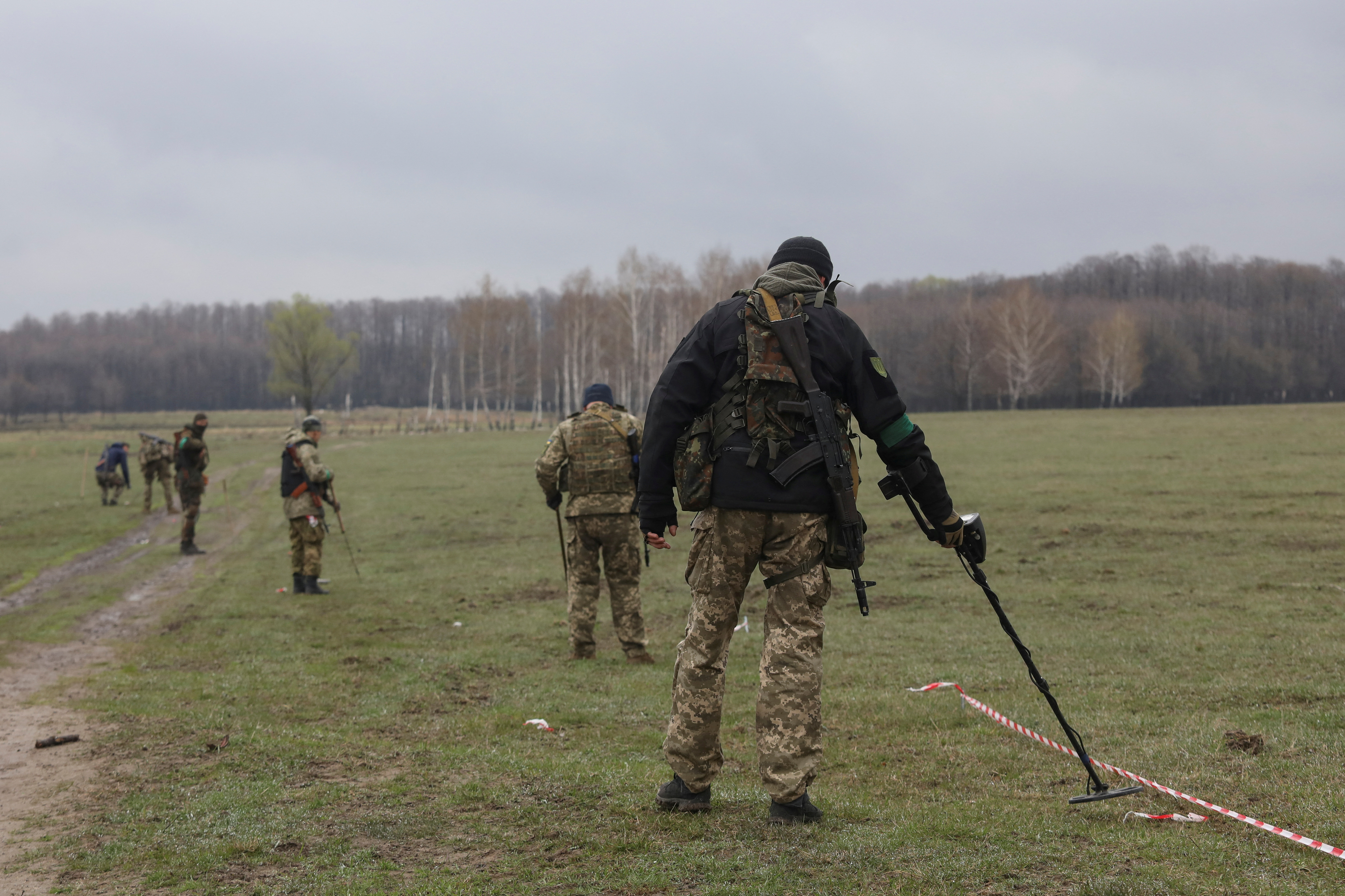 Military sappers inspect an area for mines and non-exploded shells left after Russia's invasion in Kyiv Region