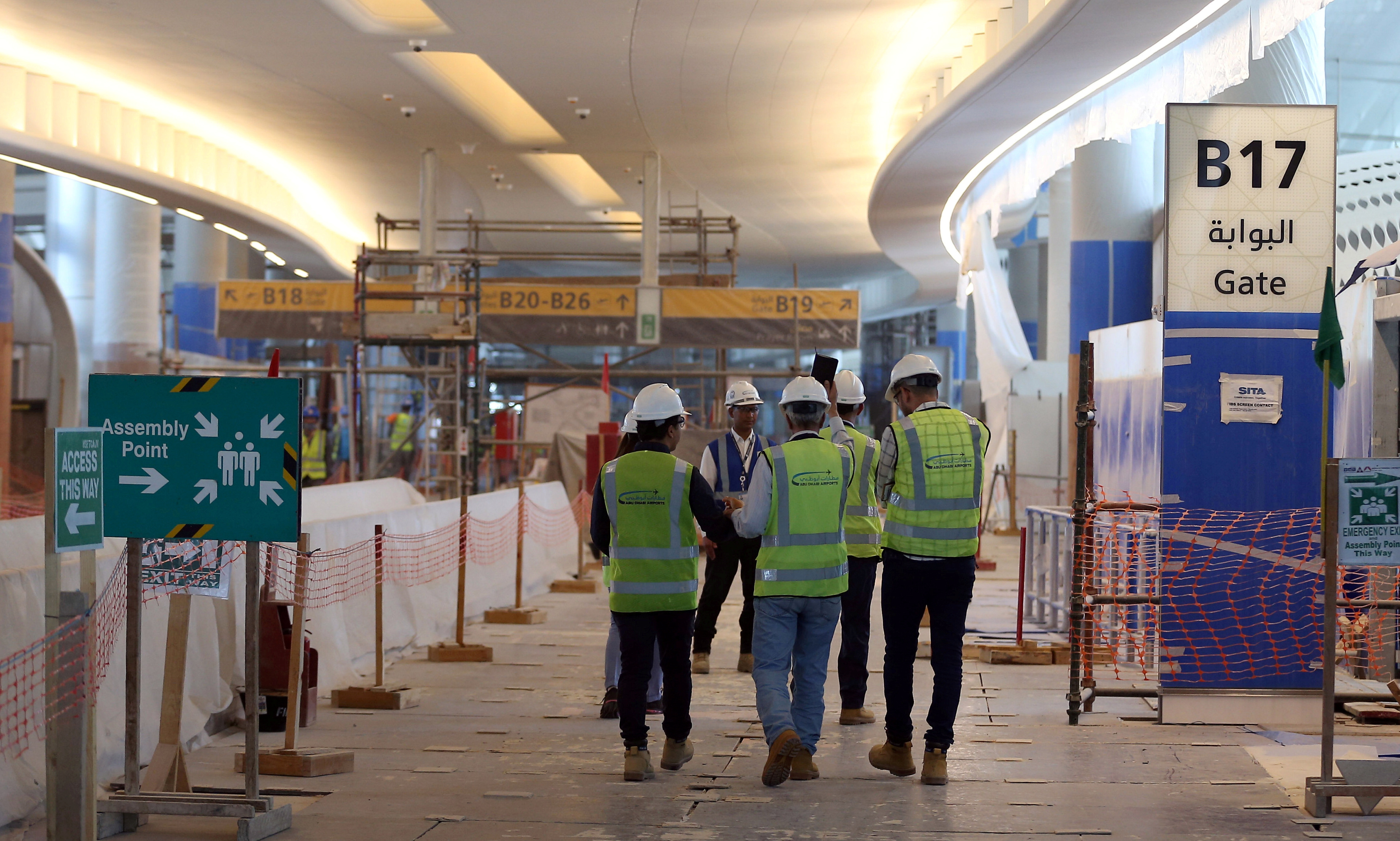 Visitors tour the construction site of the midfield terminal of Abu Dhabi International Airport in Abu Dhabi