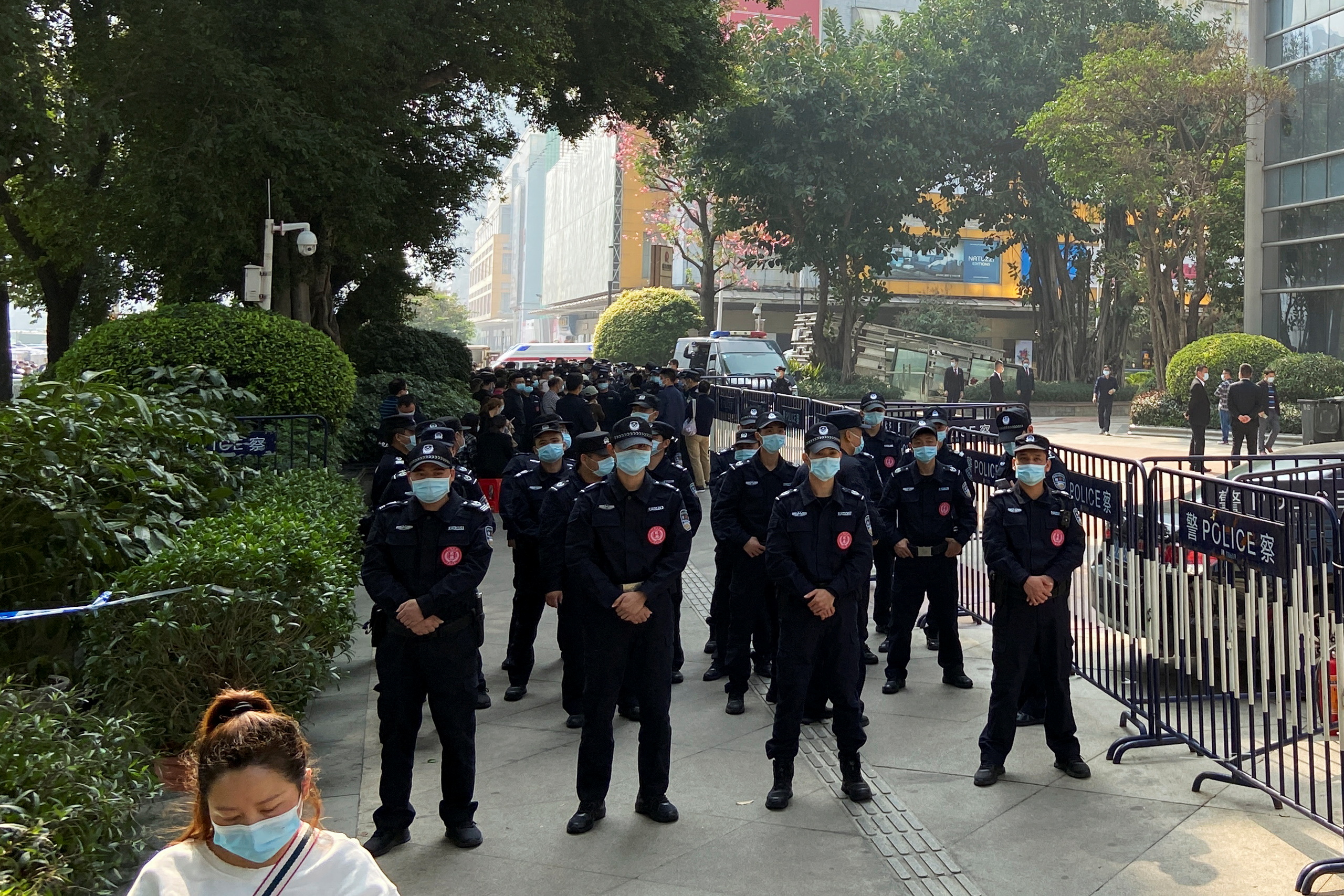 Police officers stand guard outside the Evergrande International Center in Guangzhou