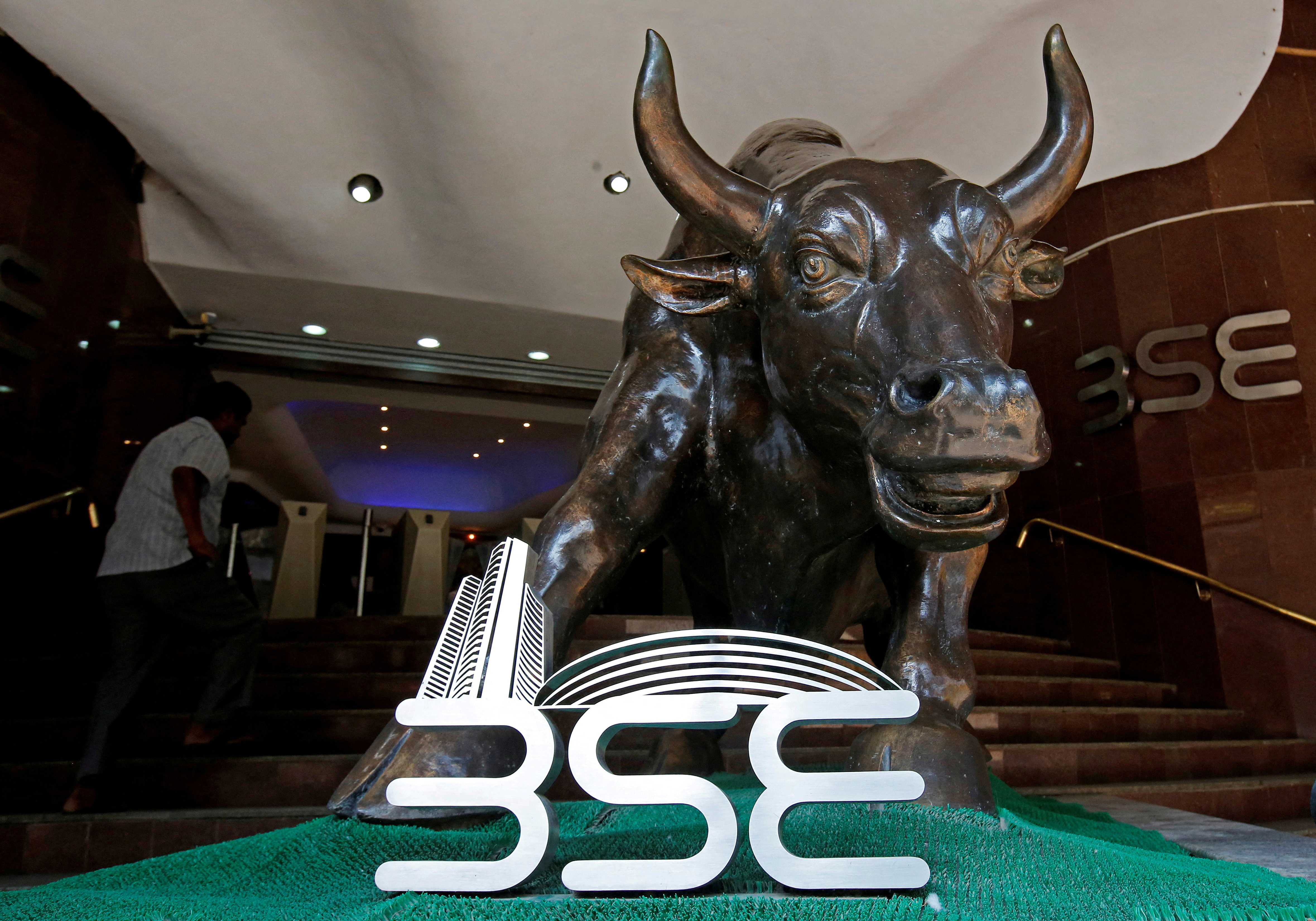 FILE PHOTO: The Bombay Stock Exchange (BSE) logo is seen under a bull statue at the entrance of their building in Mumbai